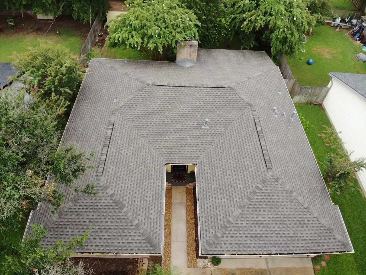 GAF architectural shingles with a ridge vent on a cross-hipped roof, offering a durable and well-ventilated roofing solution.