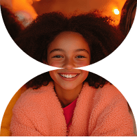 a girl with curly hair smiling