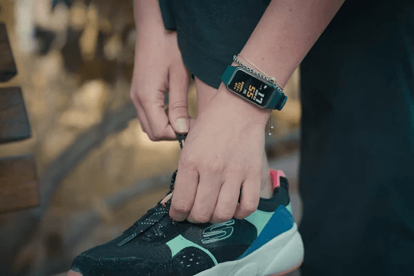 A budget and a premium fitness tracker side by side on a wrist