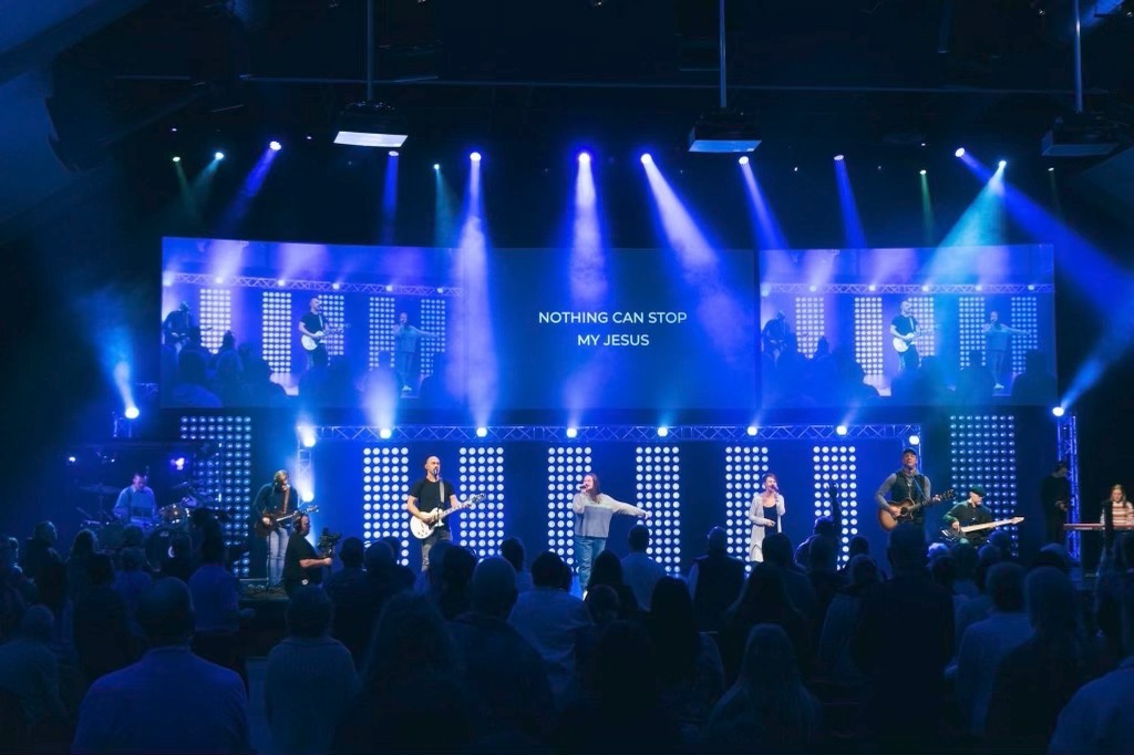 Wide angle view of Matt on church stage