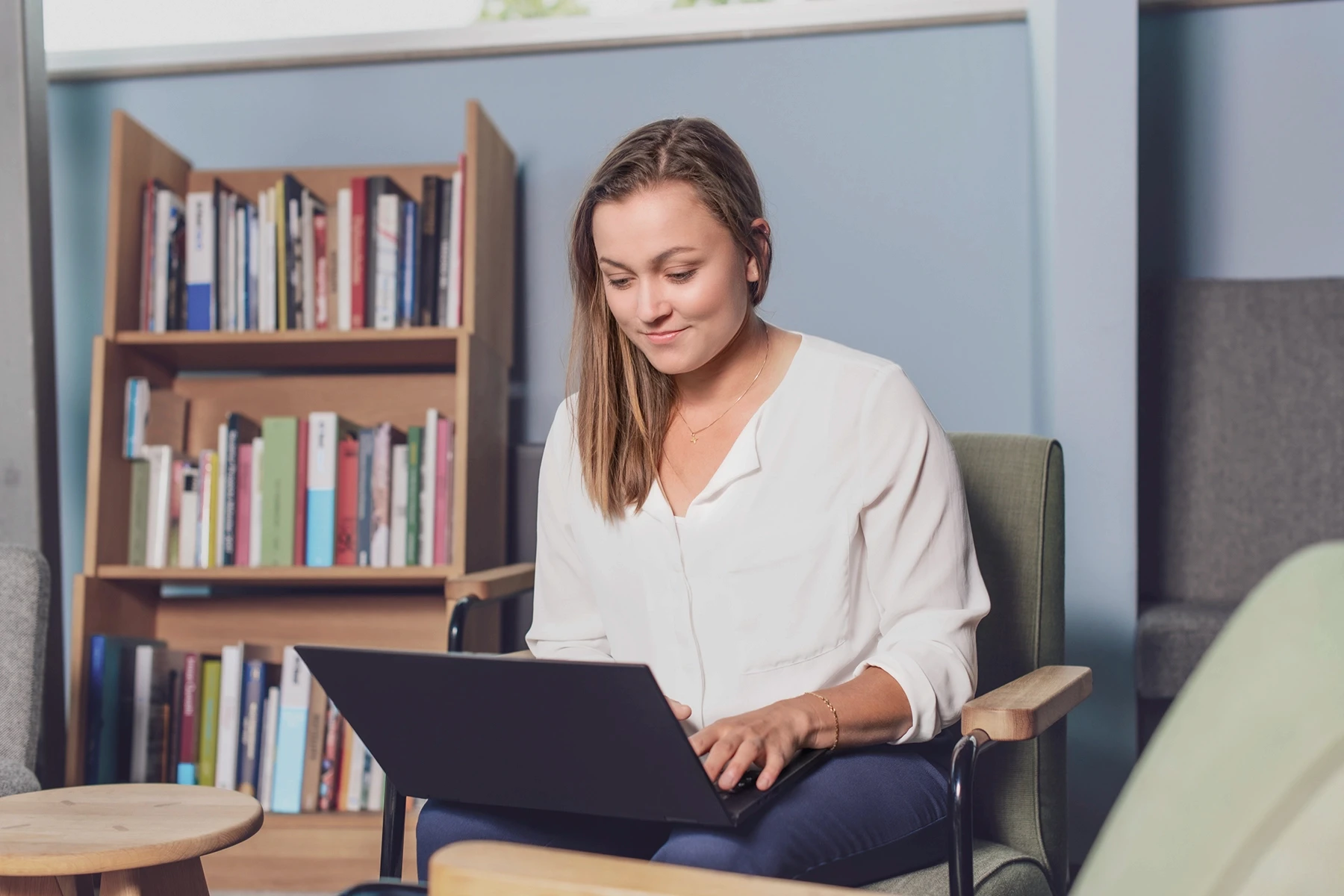 two women talking while looking at laptop computer