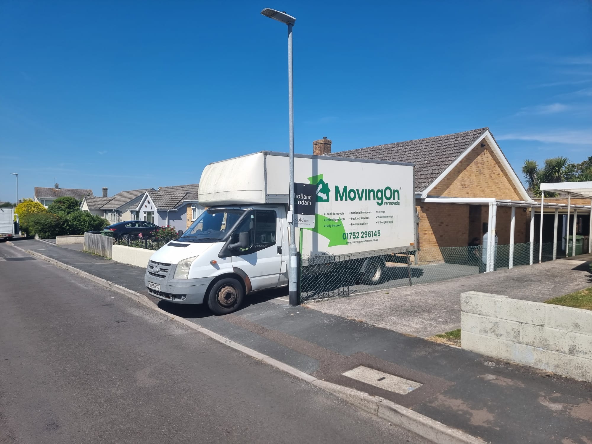 Moving On Removals van parked outside a modern bungalow for a large long-distance house removal in Ivybridge.
