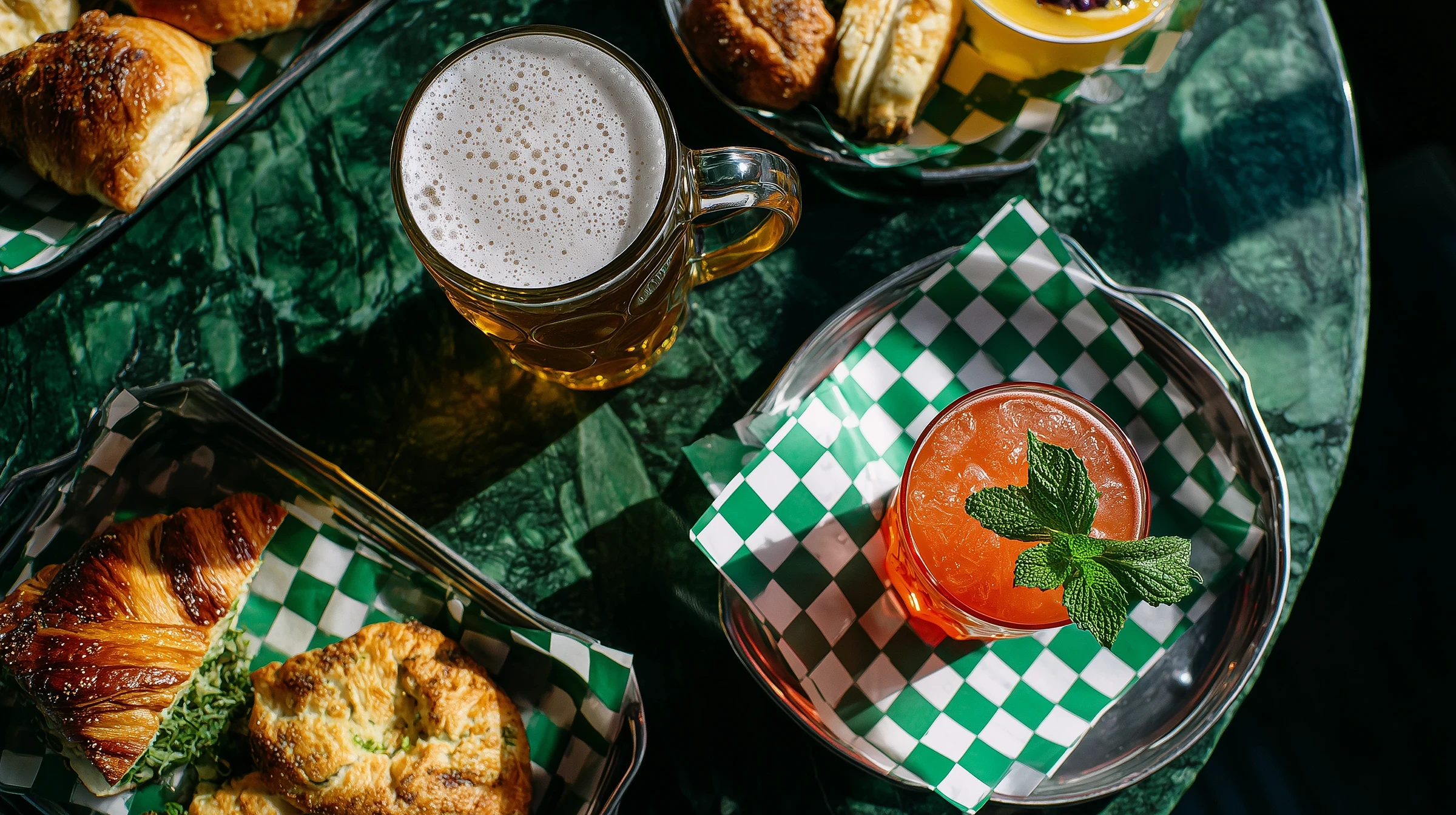 Brunch table with cocktail and beer on a marble table
