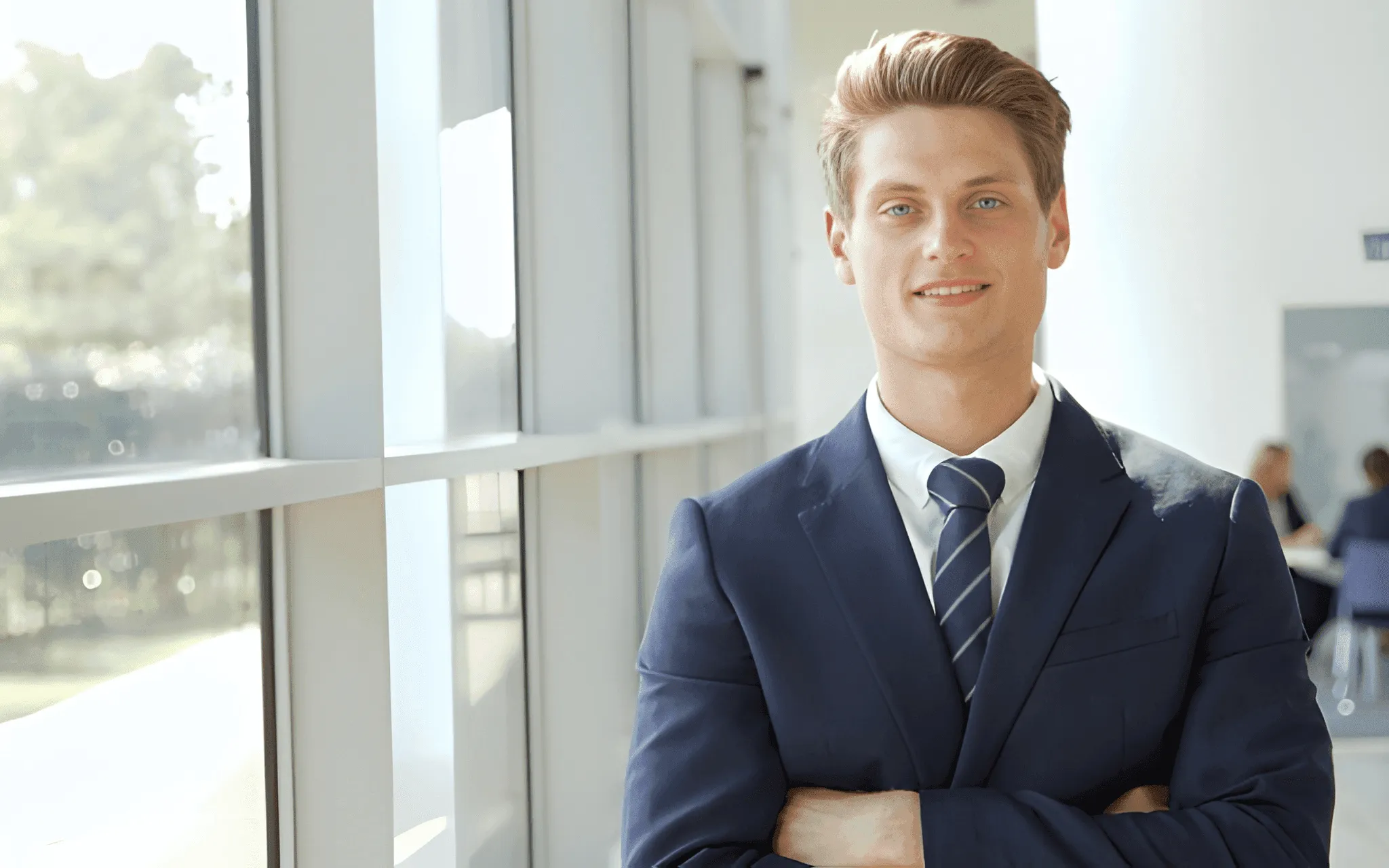 Man in suit with arms crossed smiling