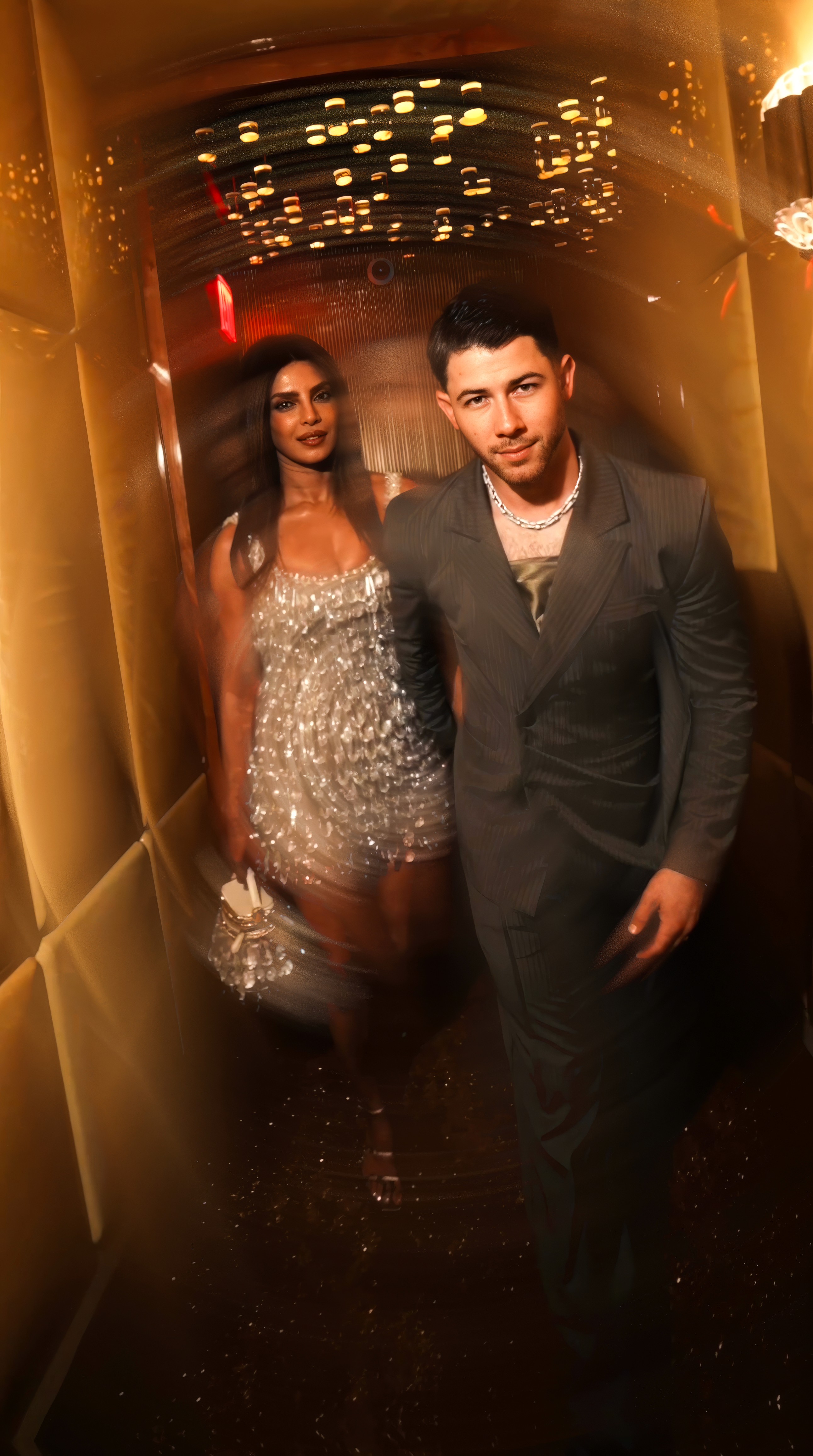 Woman in black outfit sitting on bar stool, leg extended