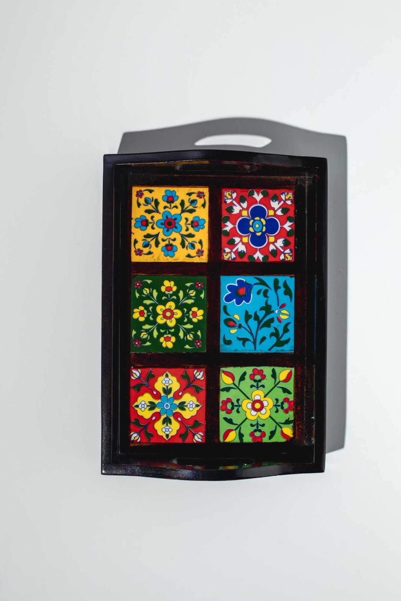 Decorative wall art with colorful floral patterns on a gray background