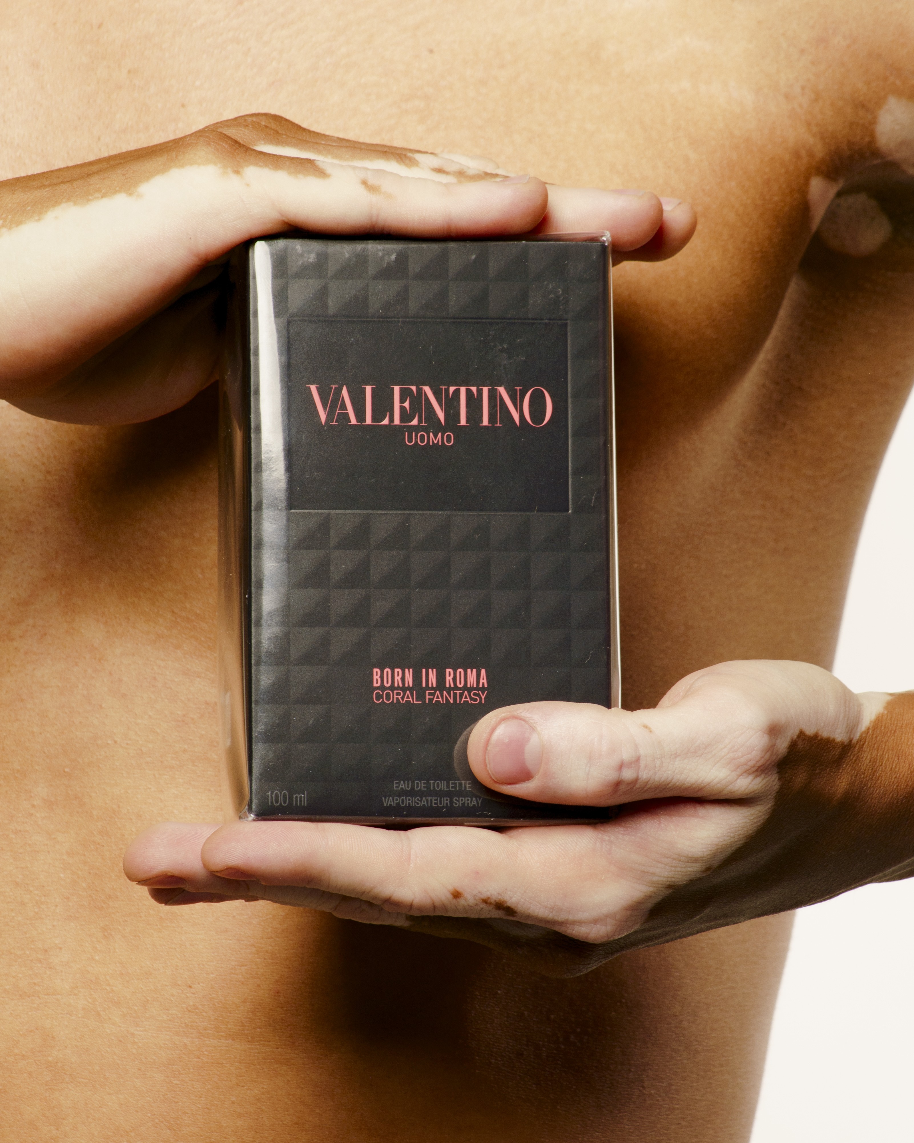 Fragrance bottle framed by Wilson Mantilla’s hands