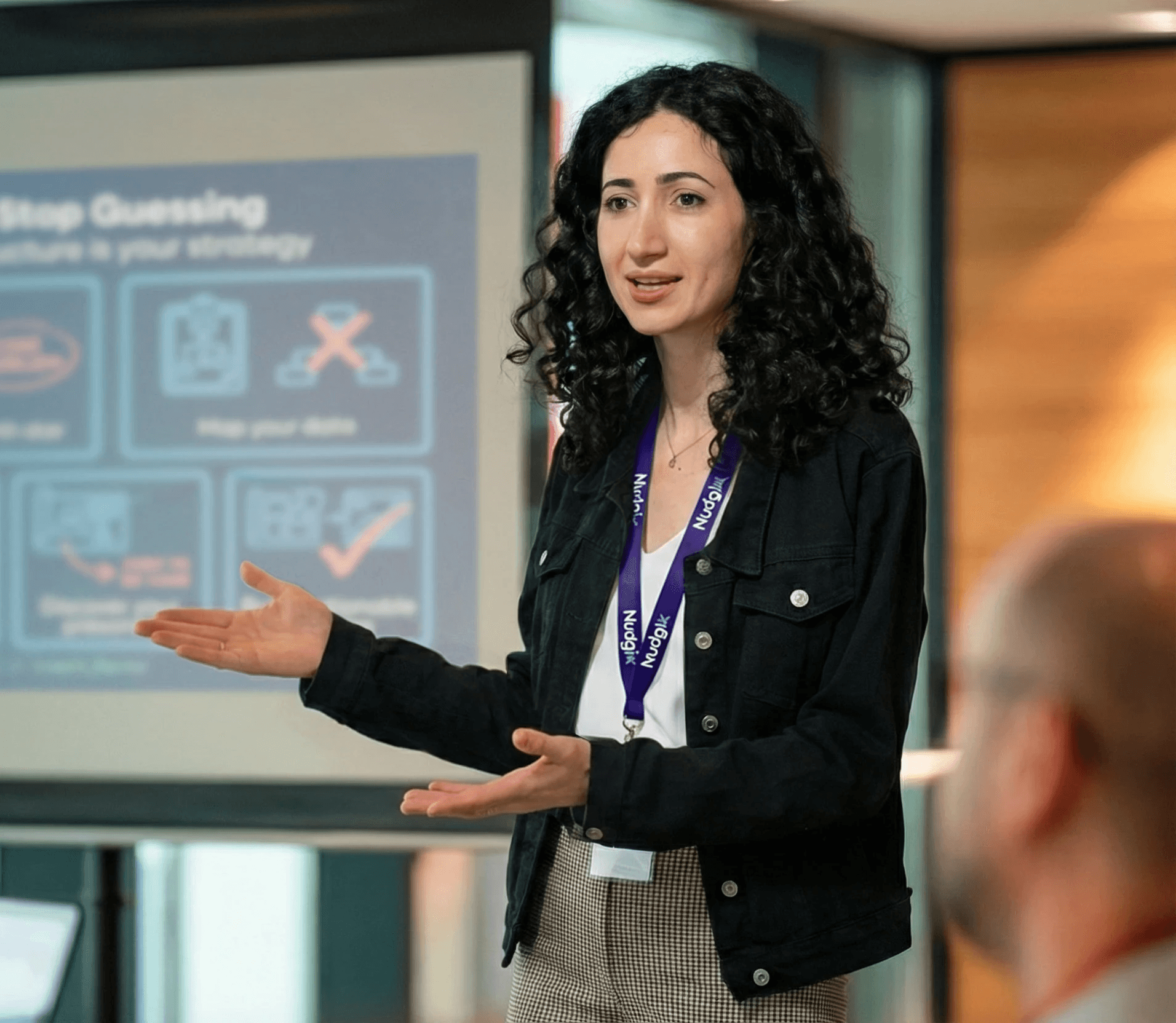 Product design strategist presenting to founders on how to transform complex technology into an investable asset for pre-seed and seed fundraising. The presentation slide, titled 'Founders: Stop Guessing,' focuses on defining a north star and mapping data to improve UX/UI strategy and prepare the MVP for investors