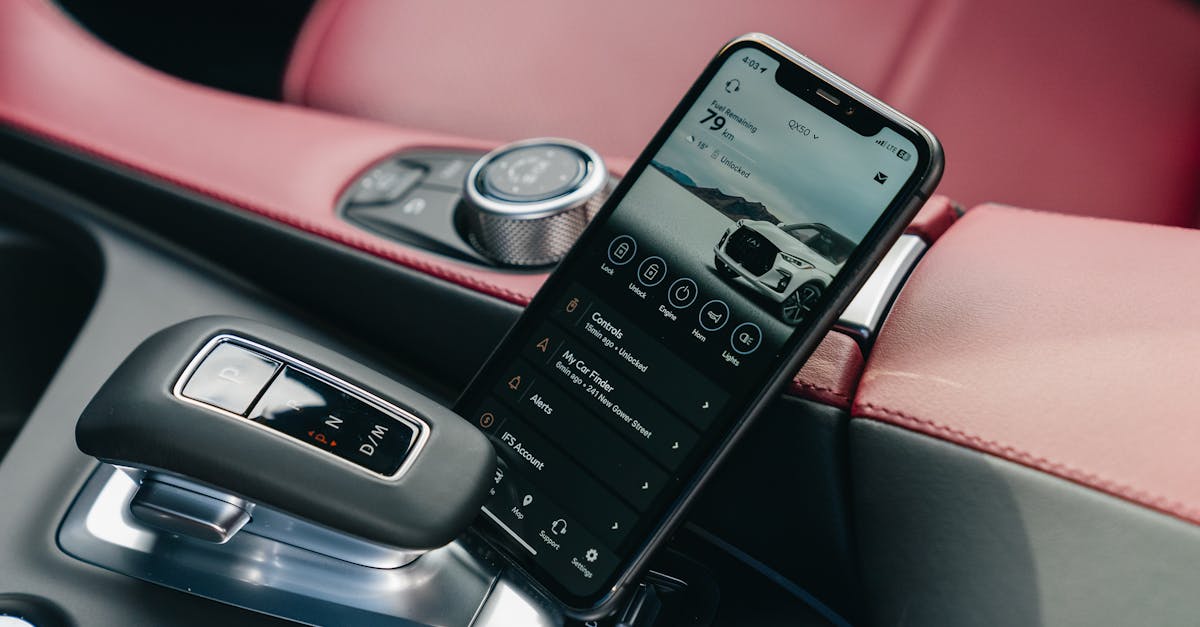 Close-up of smartphone with car control app in a luxury car's interior, showcasing modern technology