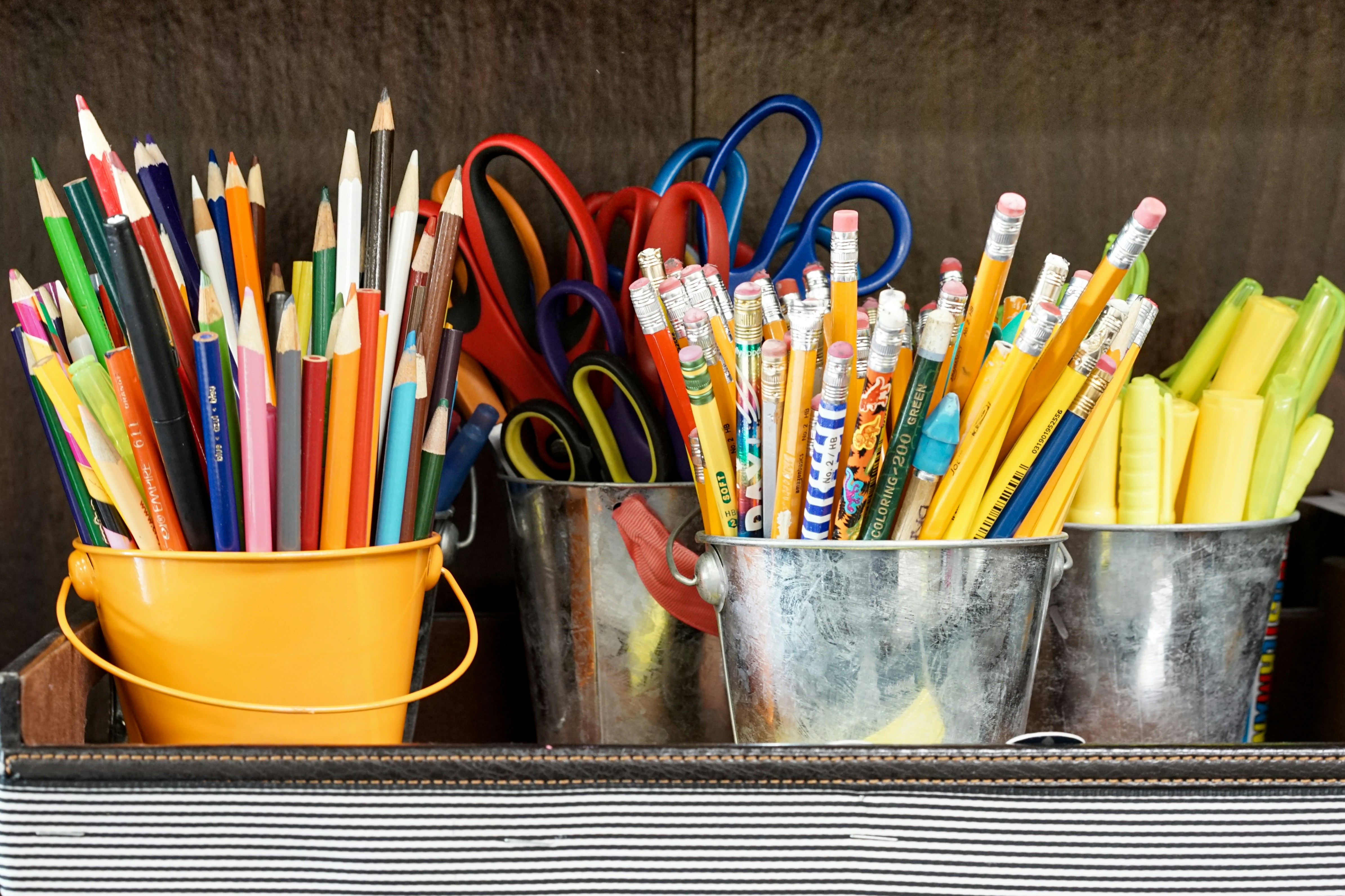 AI for Special Education represented by organized classroom supplies like pencils, markers, and scissors arranged in metal buckets.