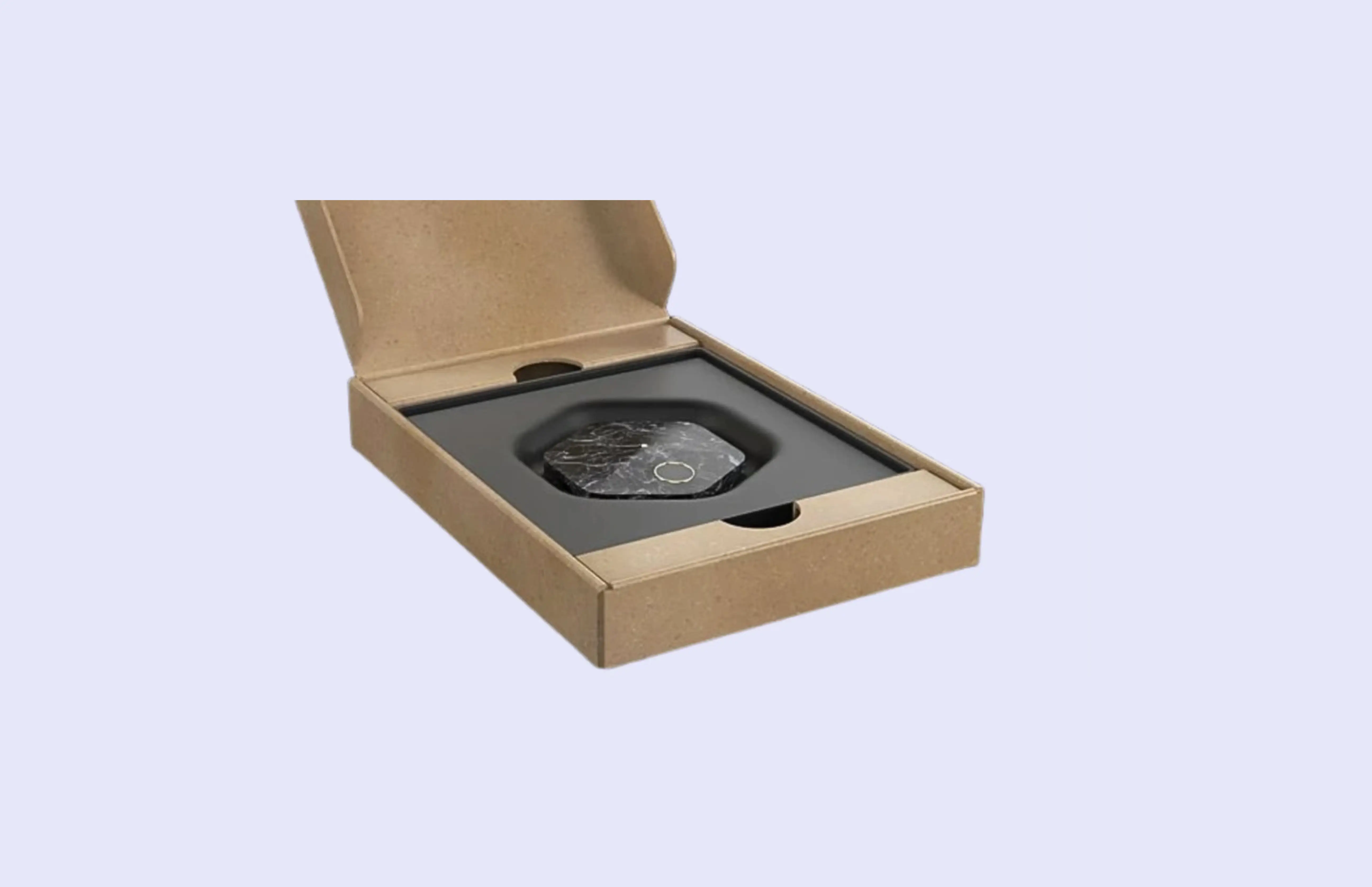 Product photo of a black Bitkey, faceted hardware wallet device sitting in a molded tray inside an open kraft-paper box