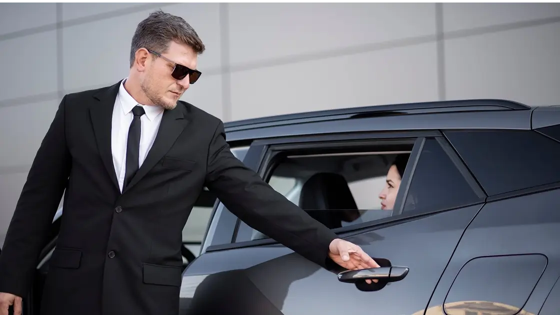 Men in a suit opening a car door