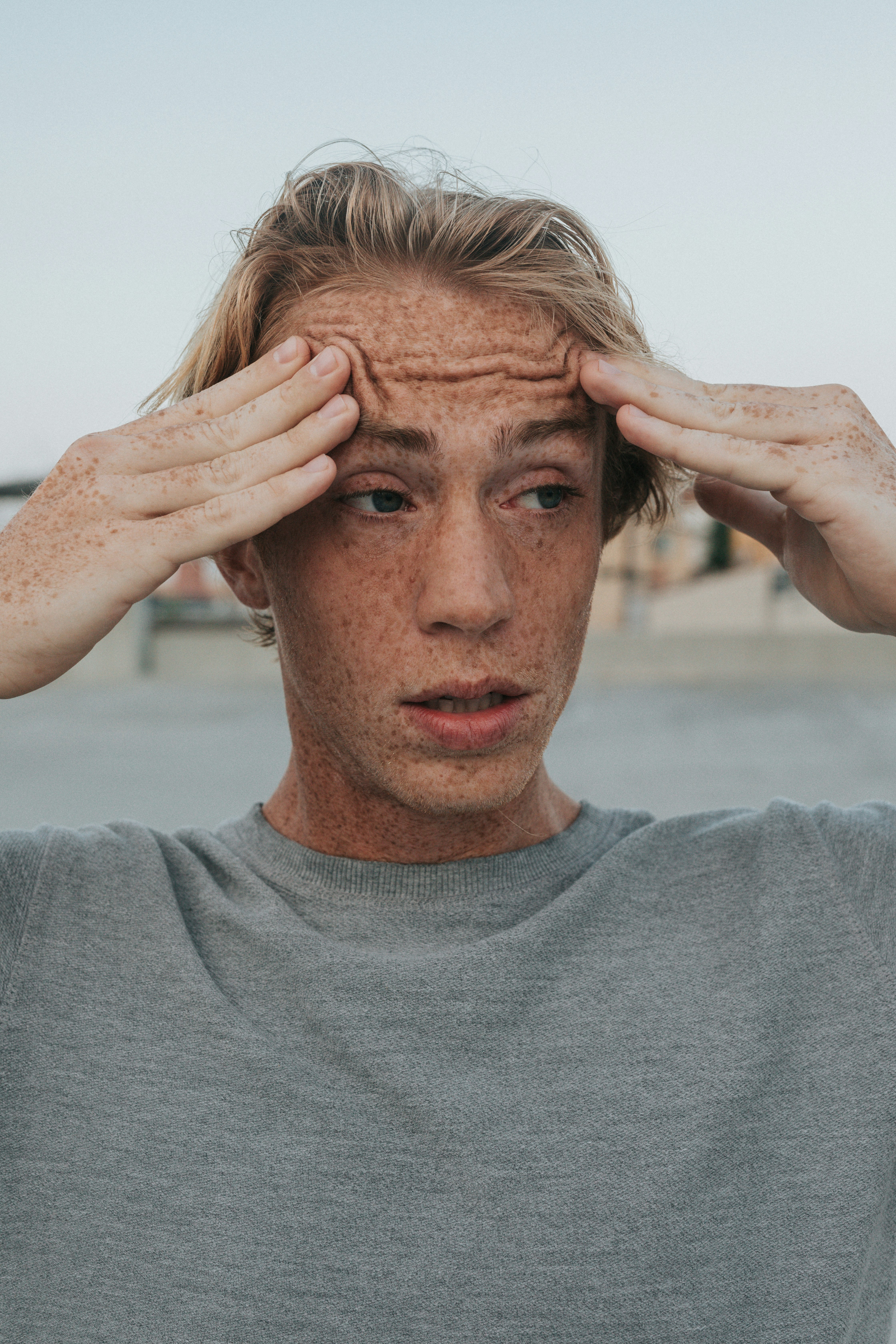 A man stressed rubbing his forehead