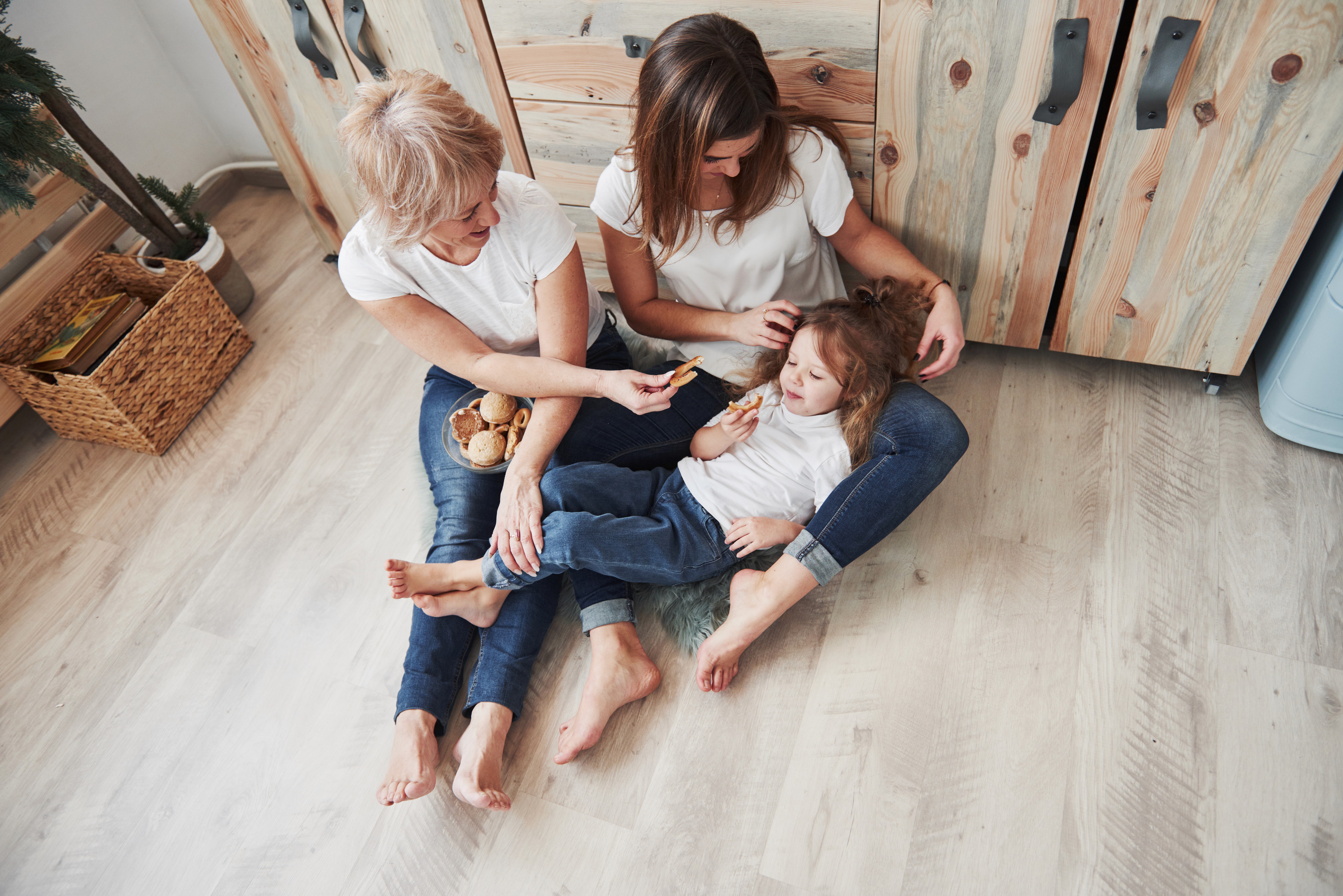 Three generations relax on LUXO Floors’ family-friendly hybrid flooring in Brisbane, showcasing durable, comfortable flooring designed for real Australian homes