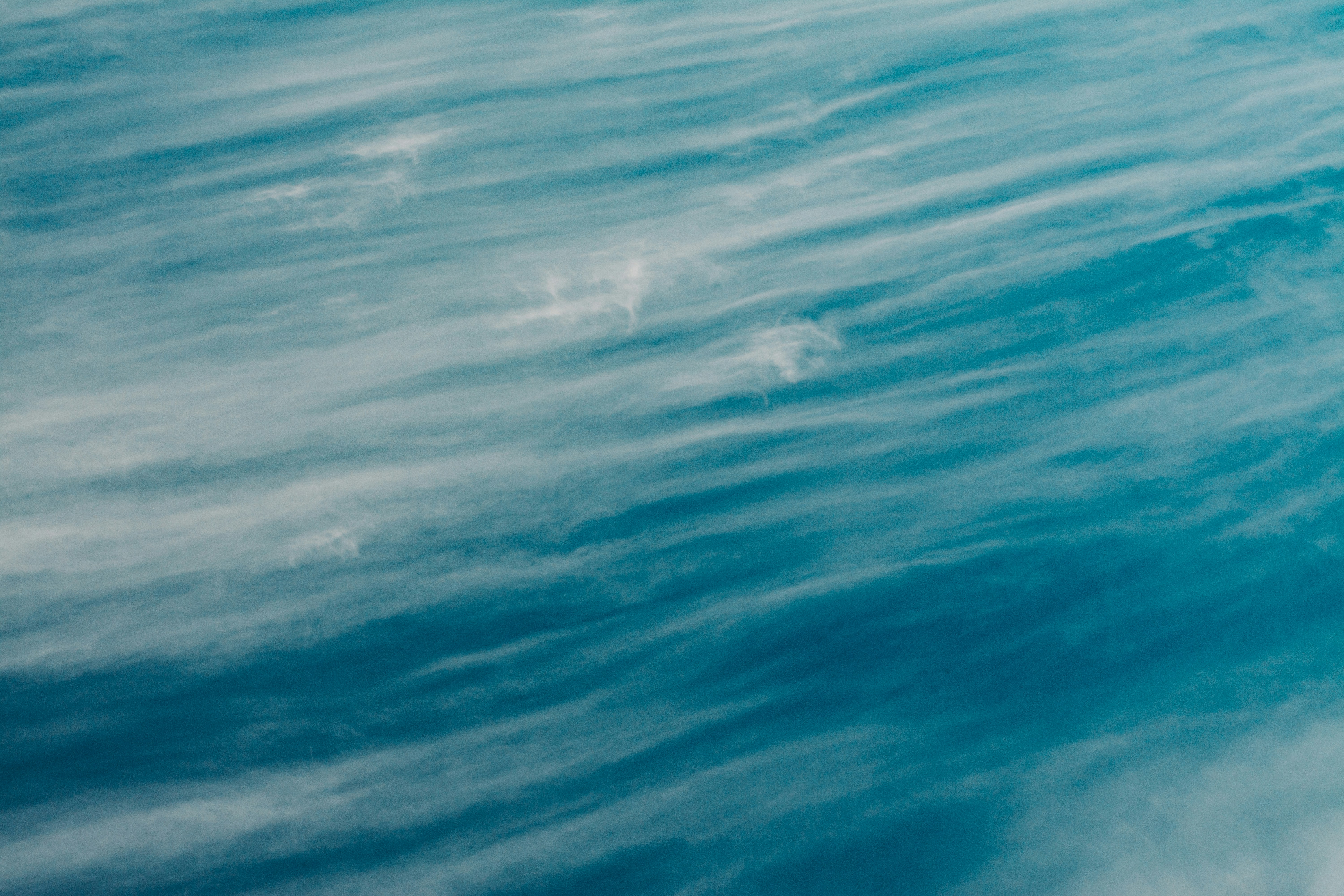 a man riding a surfboard on top of a wave