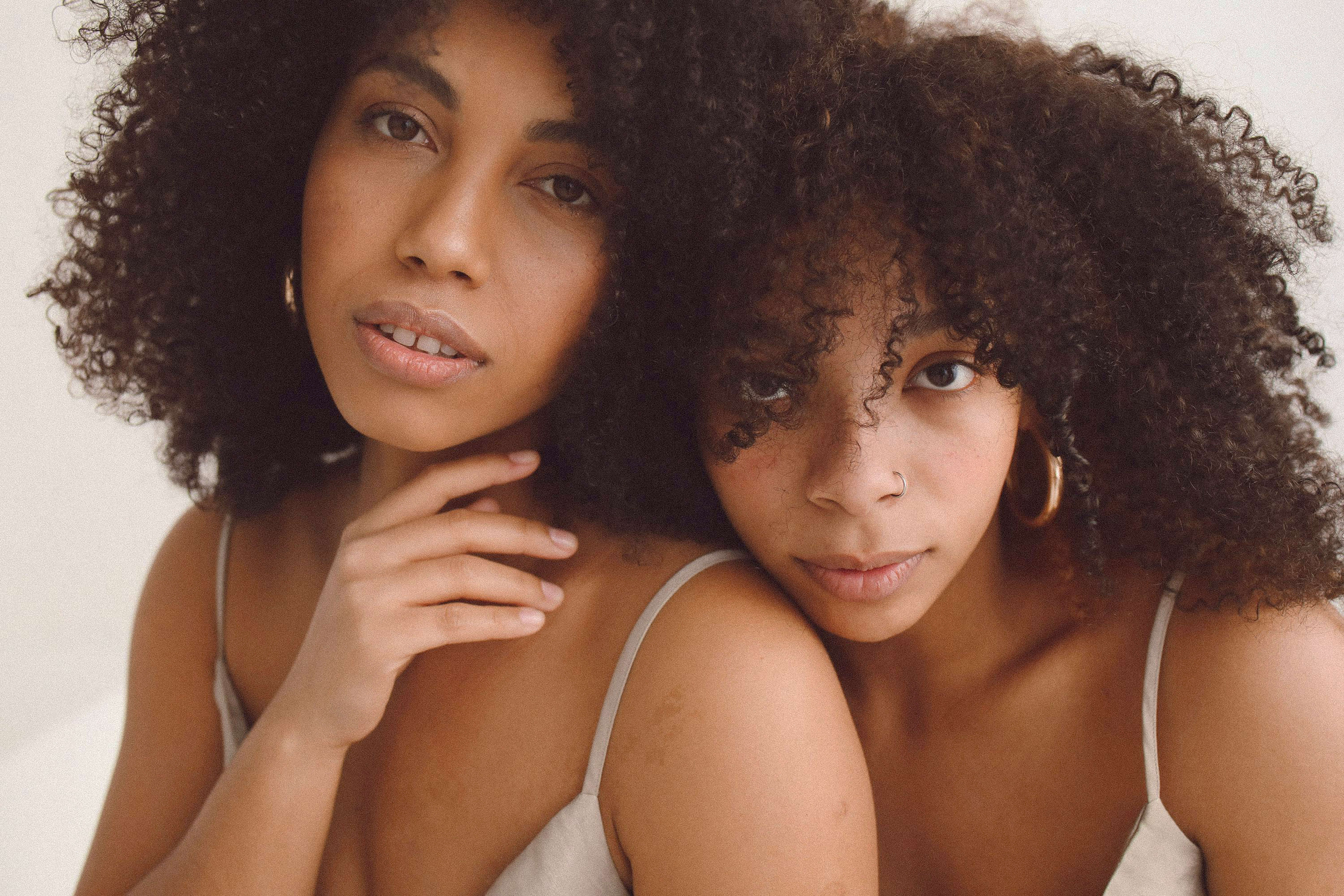 Two black women posing and looking at the camera