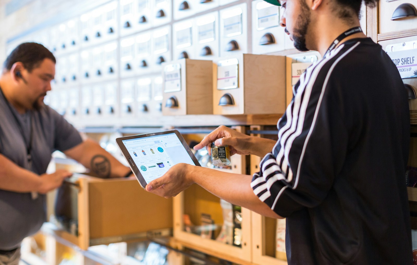 Two men in a store looking at a tablet