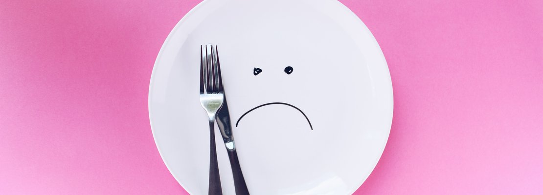an empty plate with sad emoji