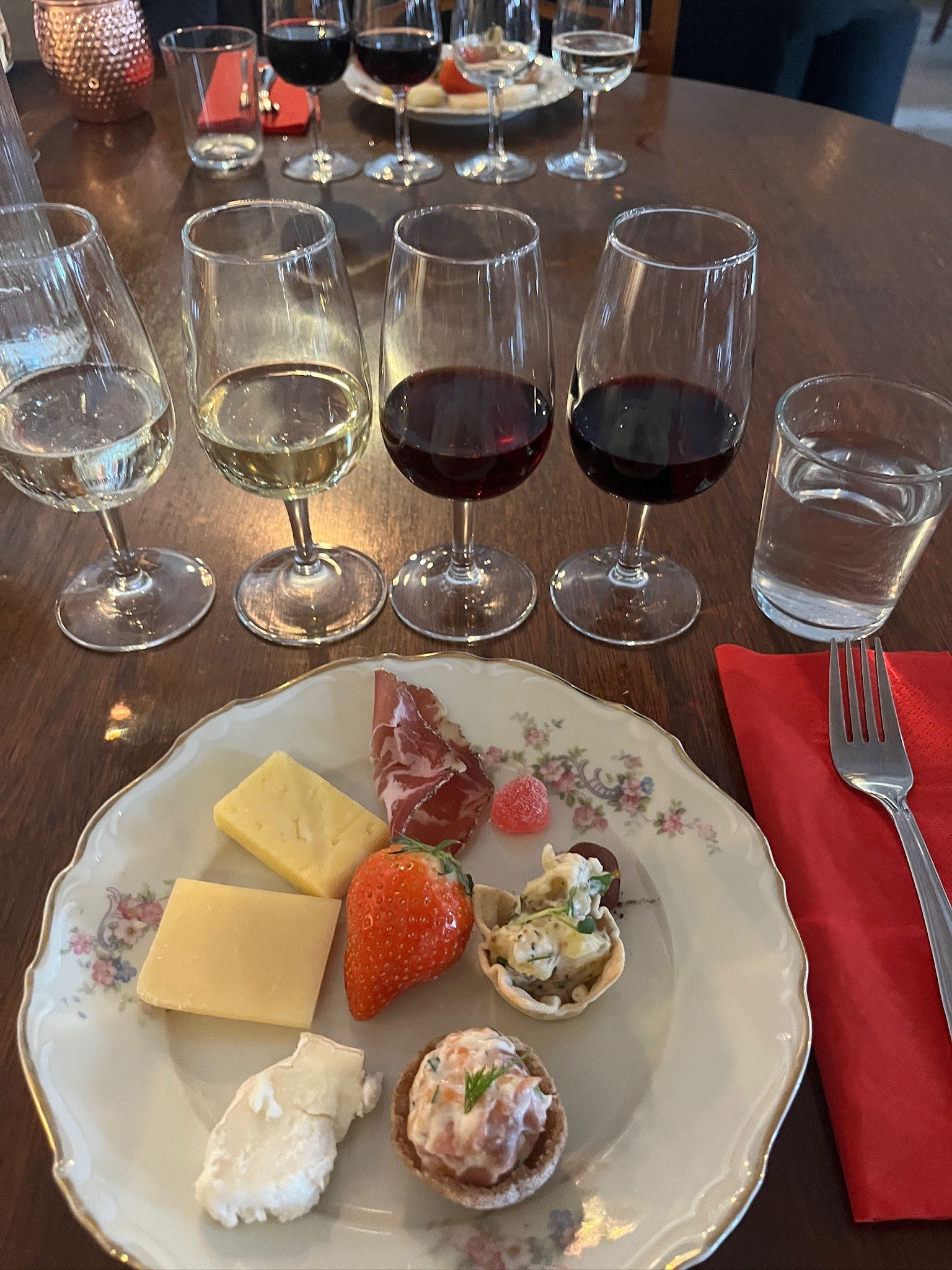 Gourmet charcuterie board with meats, cheeses, fruits, and crackers.
