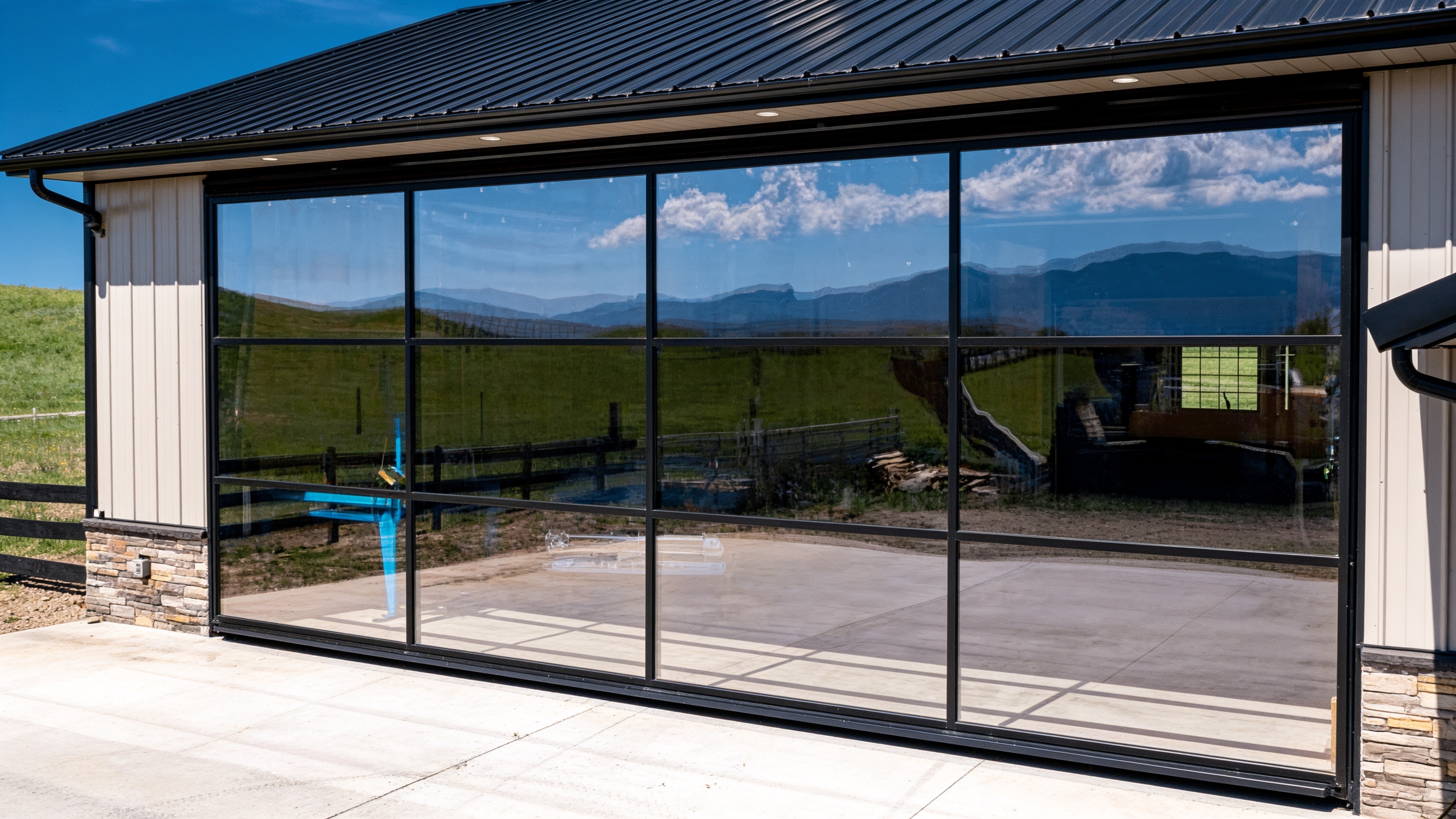 Closed insulated glass hydraulic wall door reflecting the landscape
