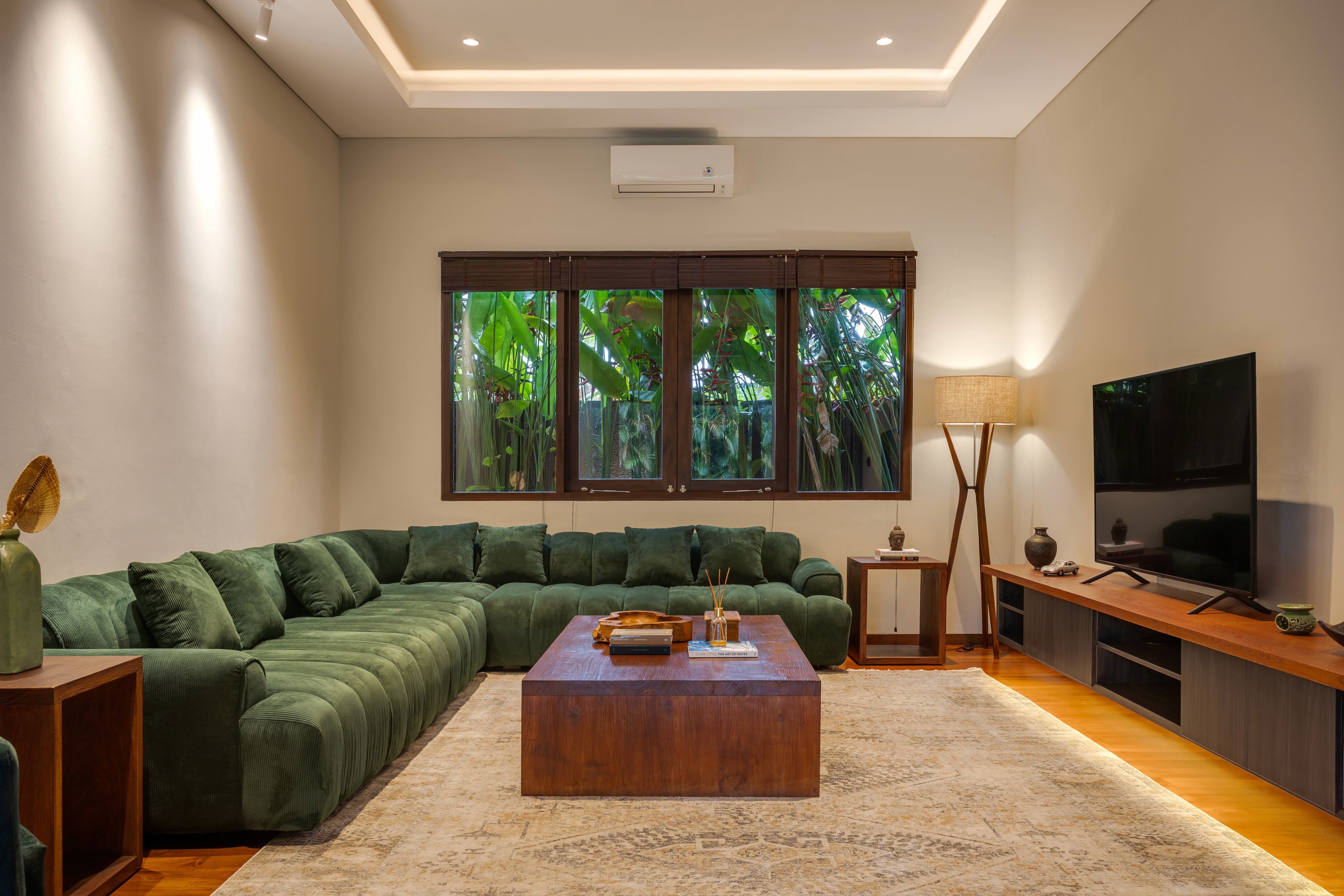 House with solar panels surrounded by forested hills