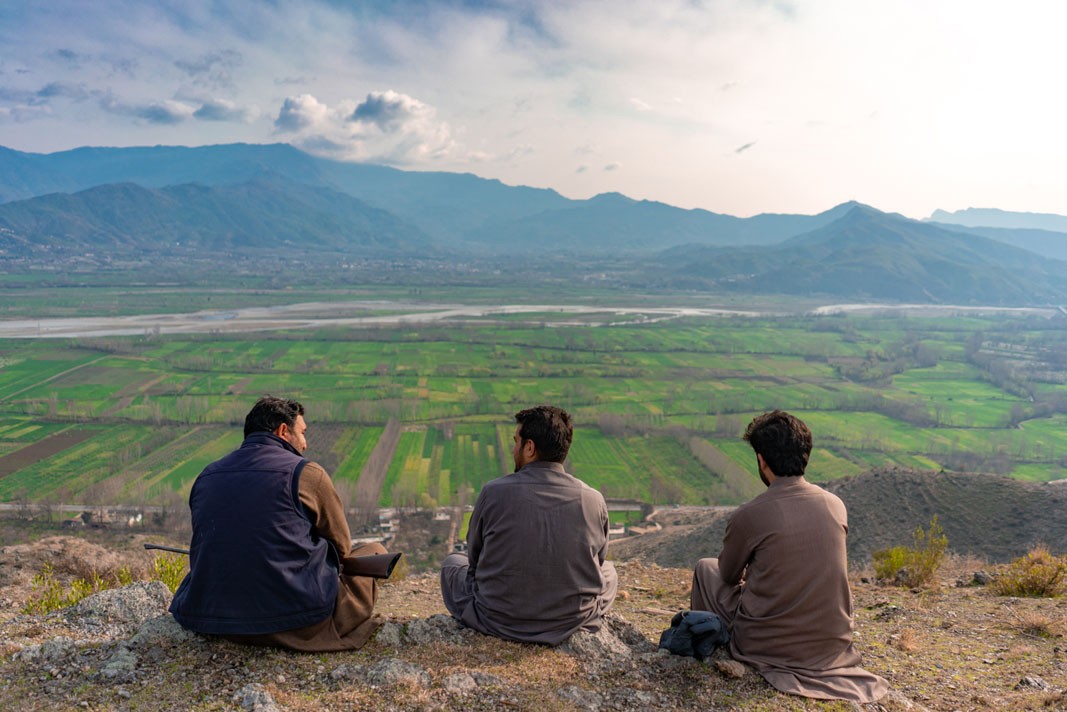 Men sitting in Swat Valley, Pakistan on a private tour organized by Coyote Den Hostel Islamabad