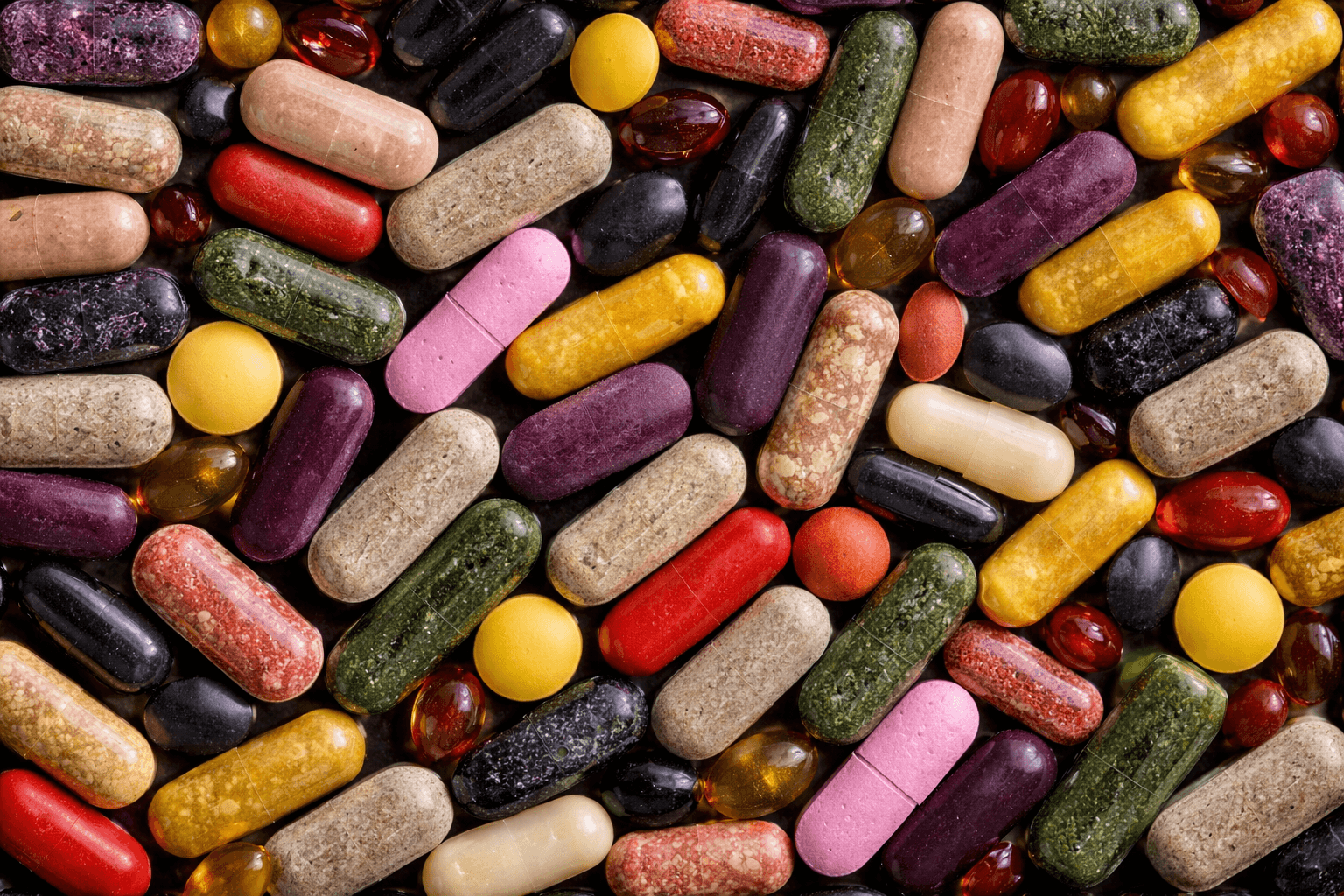 A colorful assortment of vitamins and supplements in various shapes and sizes.