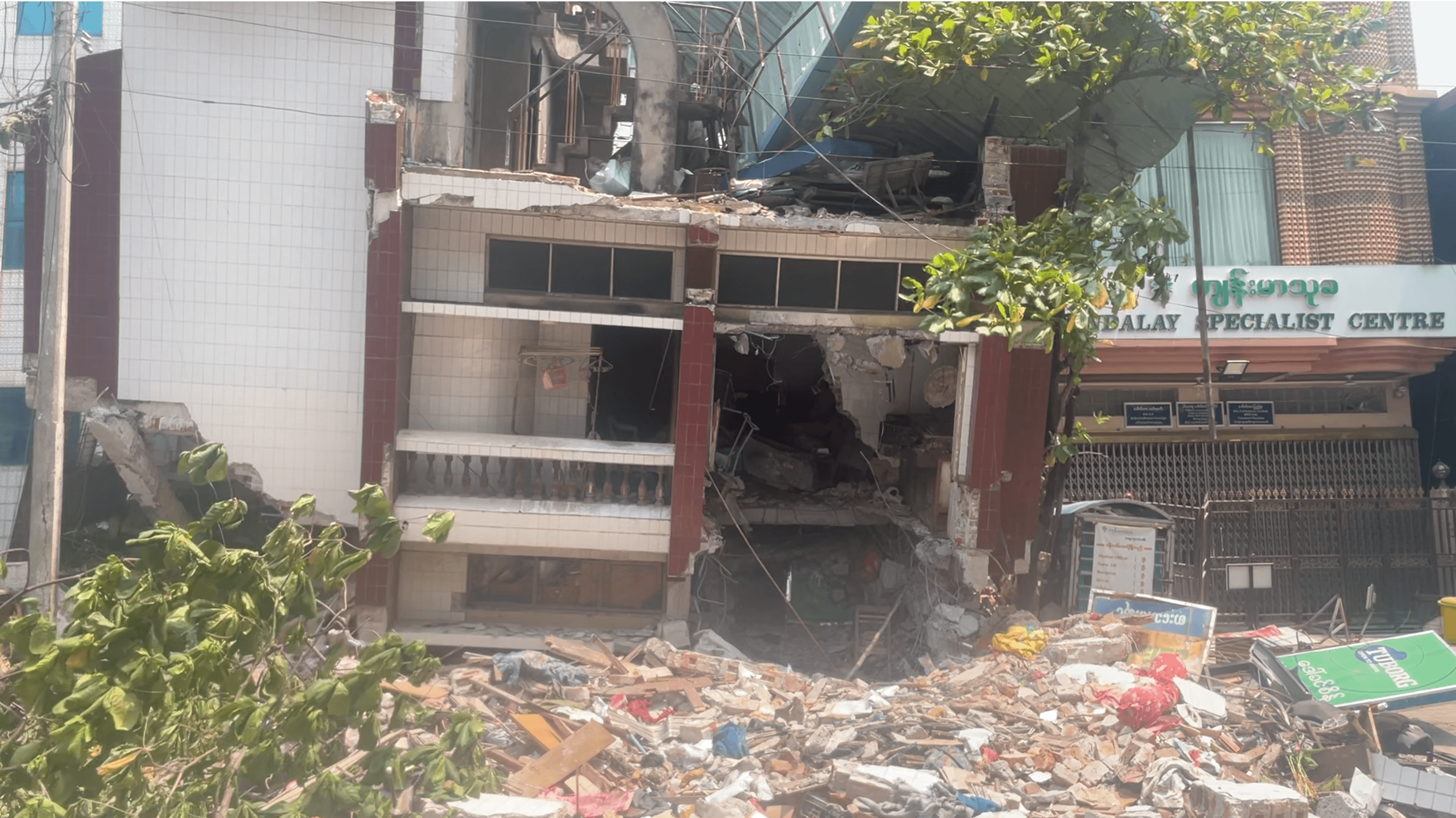 man in black polo shirt wearing white mask holding black camera