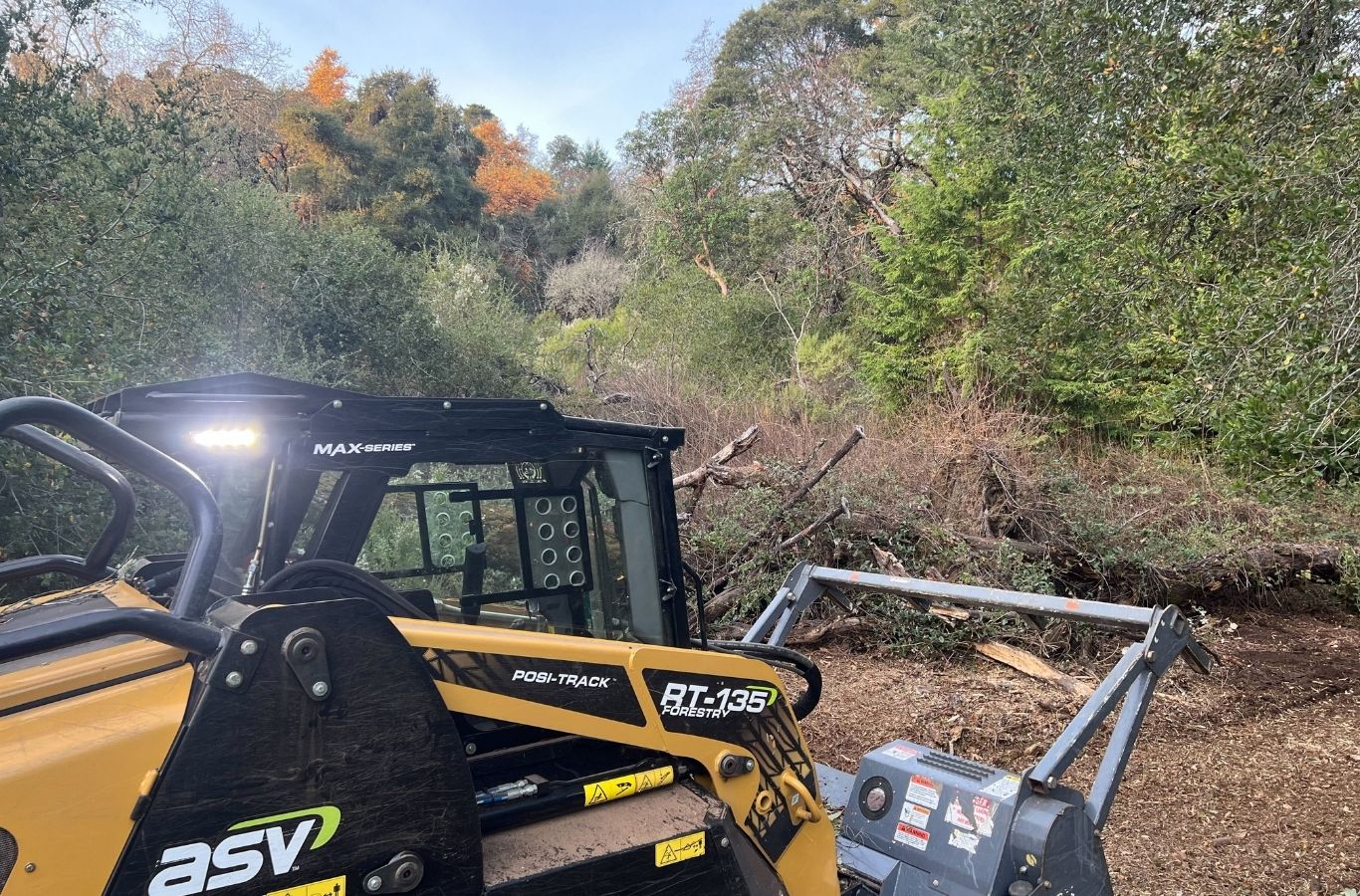 Lisac General Engineering team clearing dense vegetation in Corralitos, CA with advanced machinery for efficient land preparation.