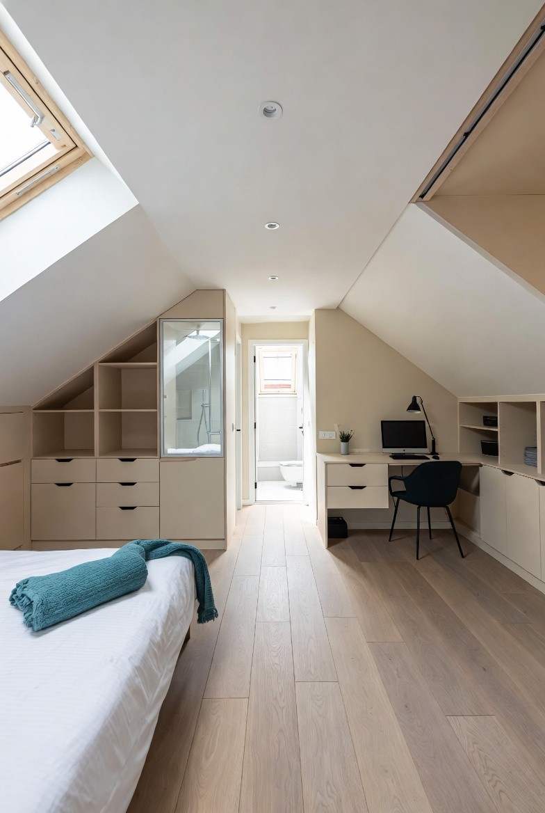 white bed linen with throw pillows