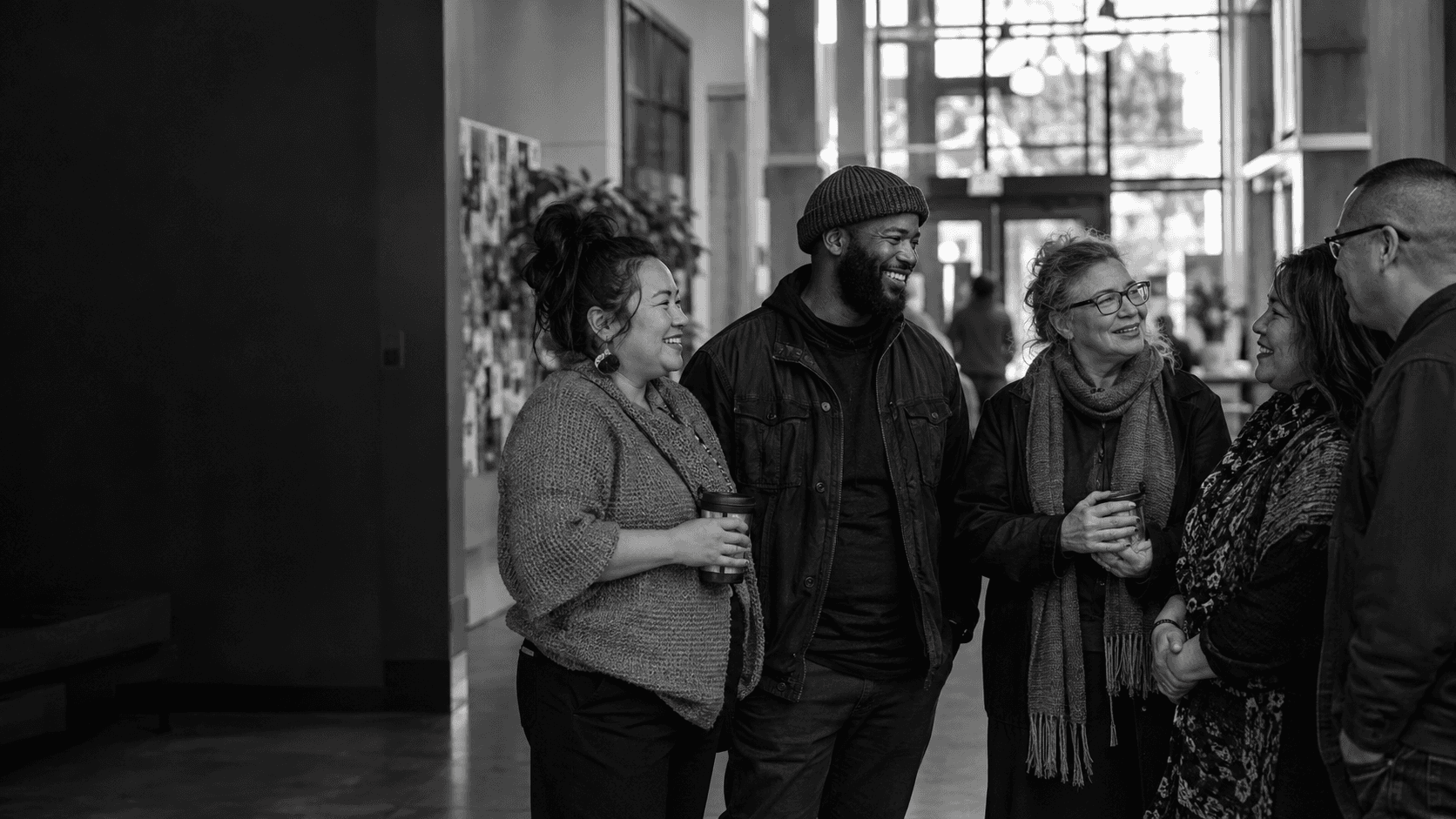 A diverse group of nonprofit leaders and frontline staff connecting inside a community centre