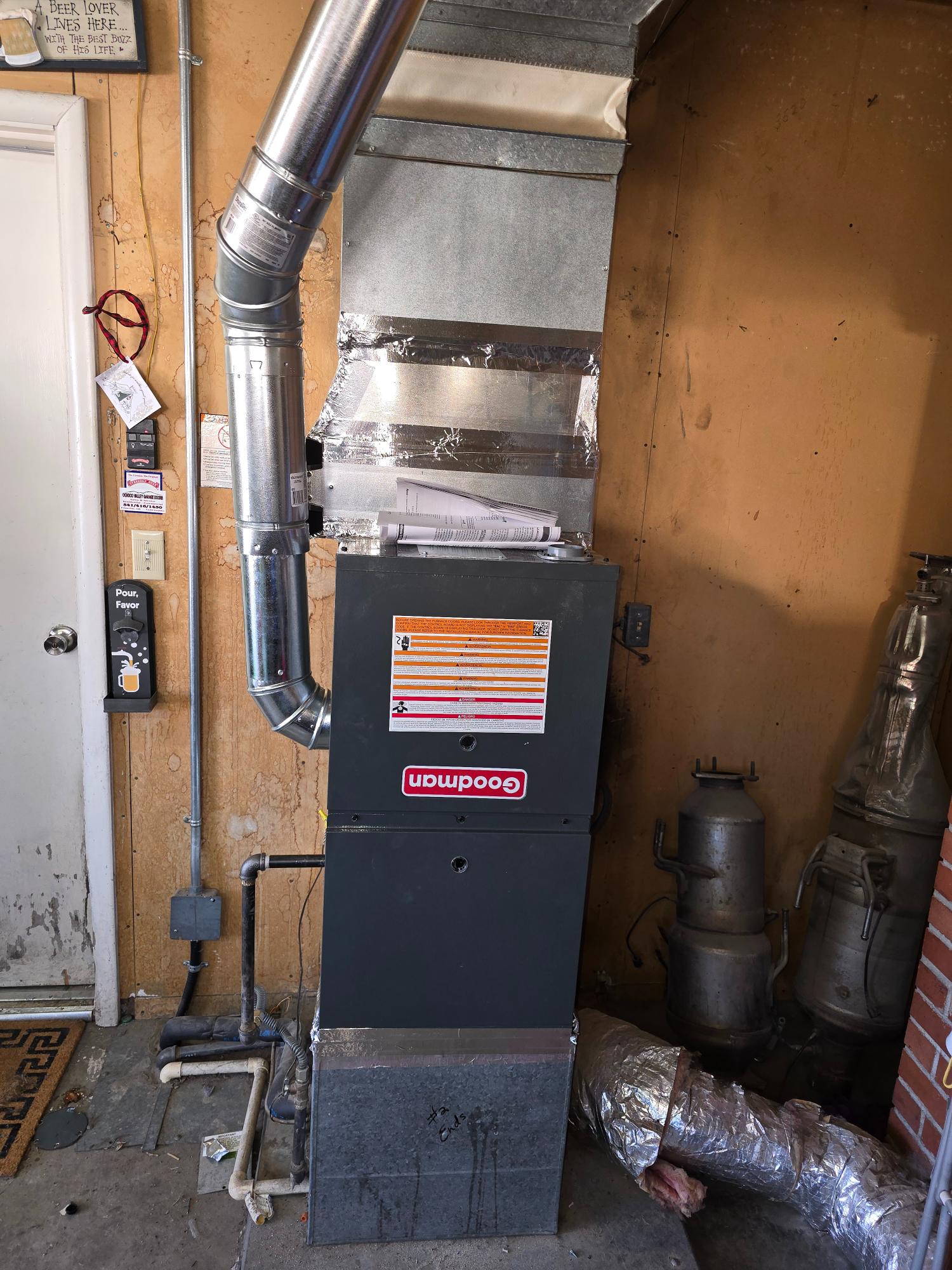Goodman furnace system installed in a garage.