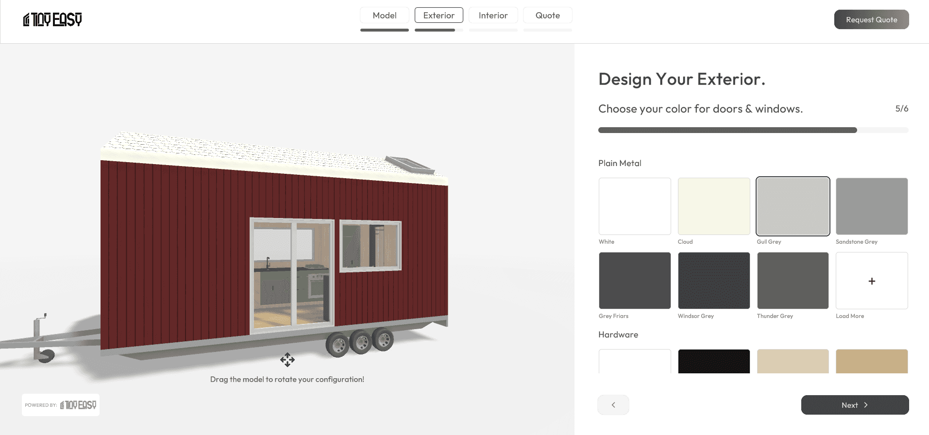 An image of a 3D tiny home on wheels painted red with a white roof. It's showcasing the exterior color in the 3D product configurator it's being edited in.