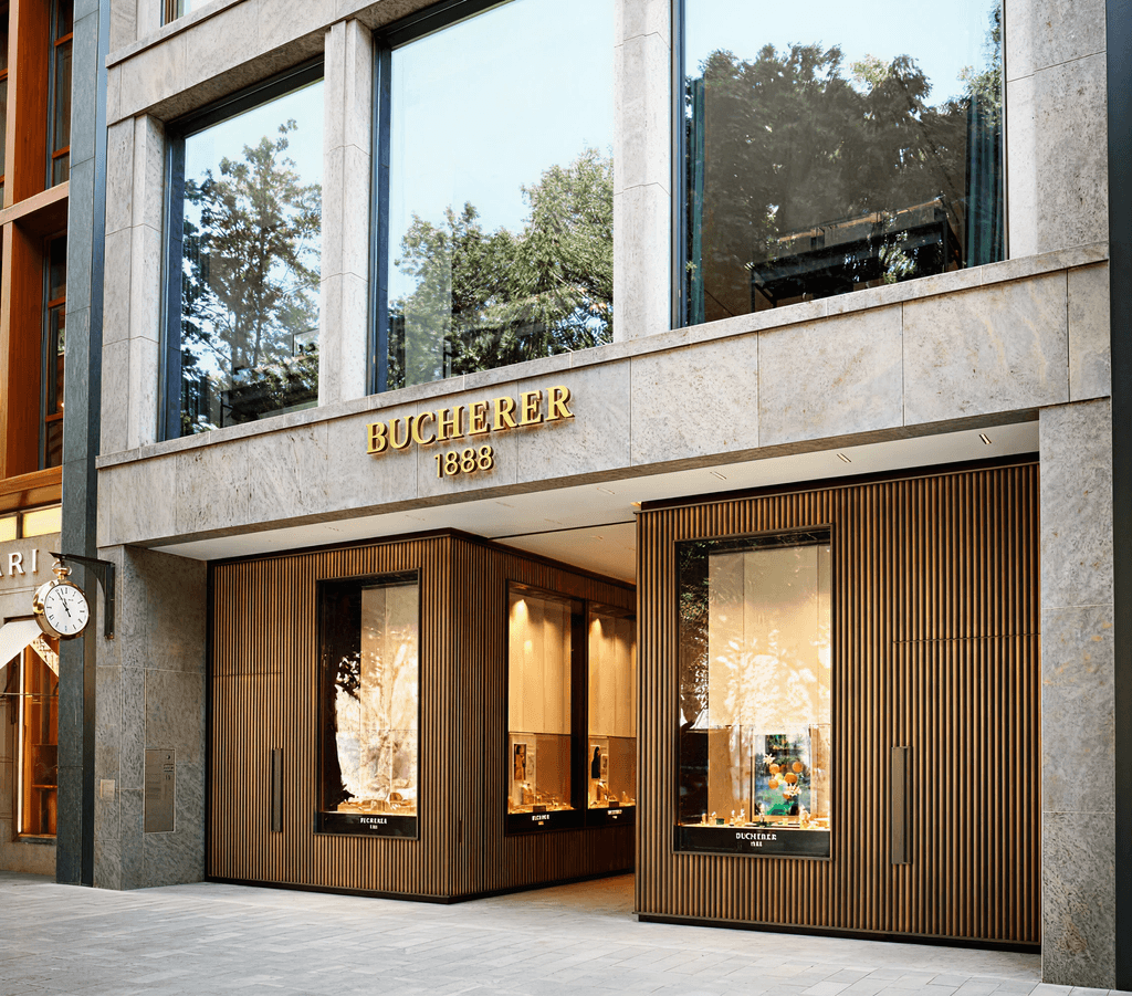 Bucherer store front with large windows and gold lettering above the entrance, showcasing luxury items.