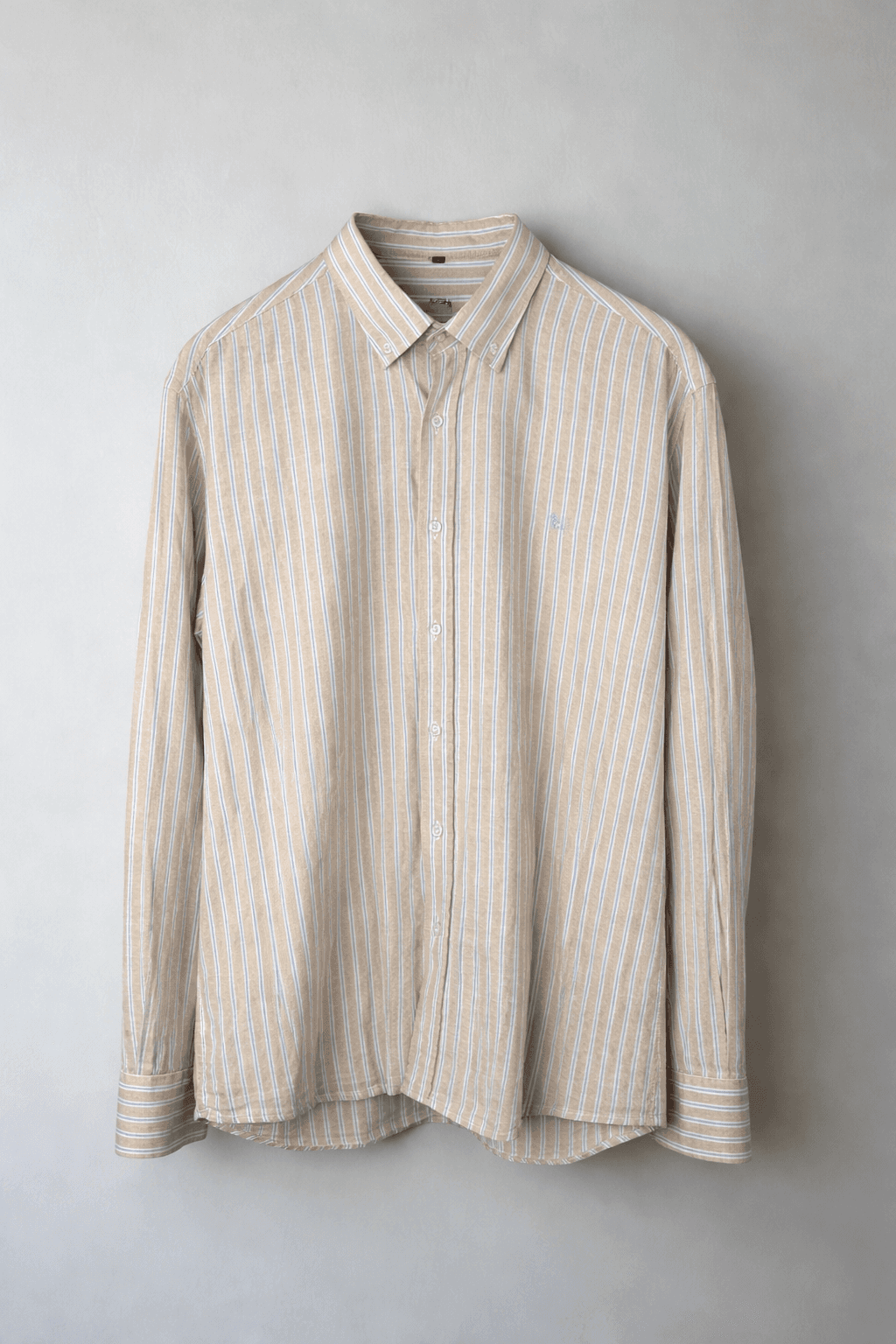 Striped beige long-sleeve casual shirt hanging