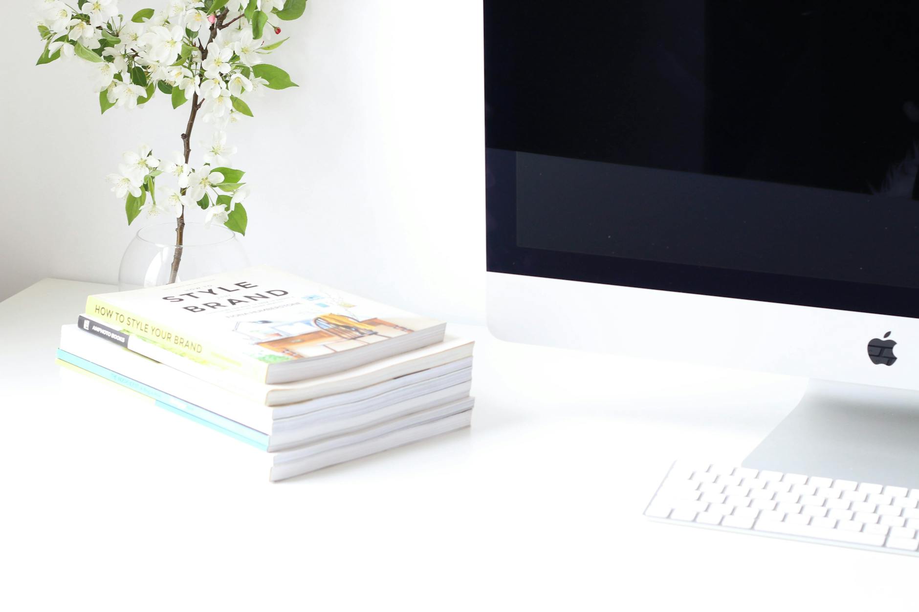A professional team shaking hands in a bright office after completing a successful curriculum development project.
