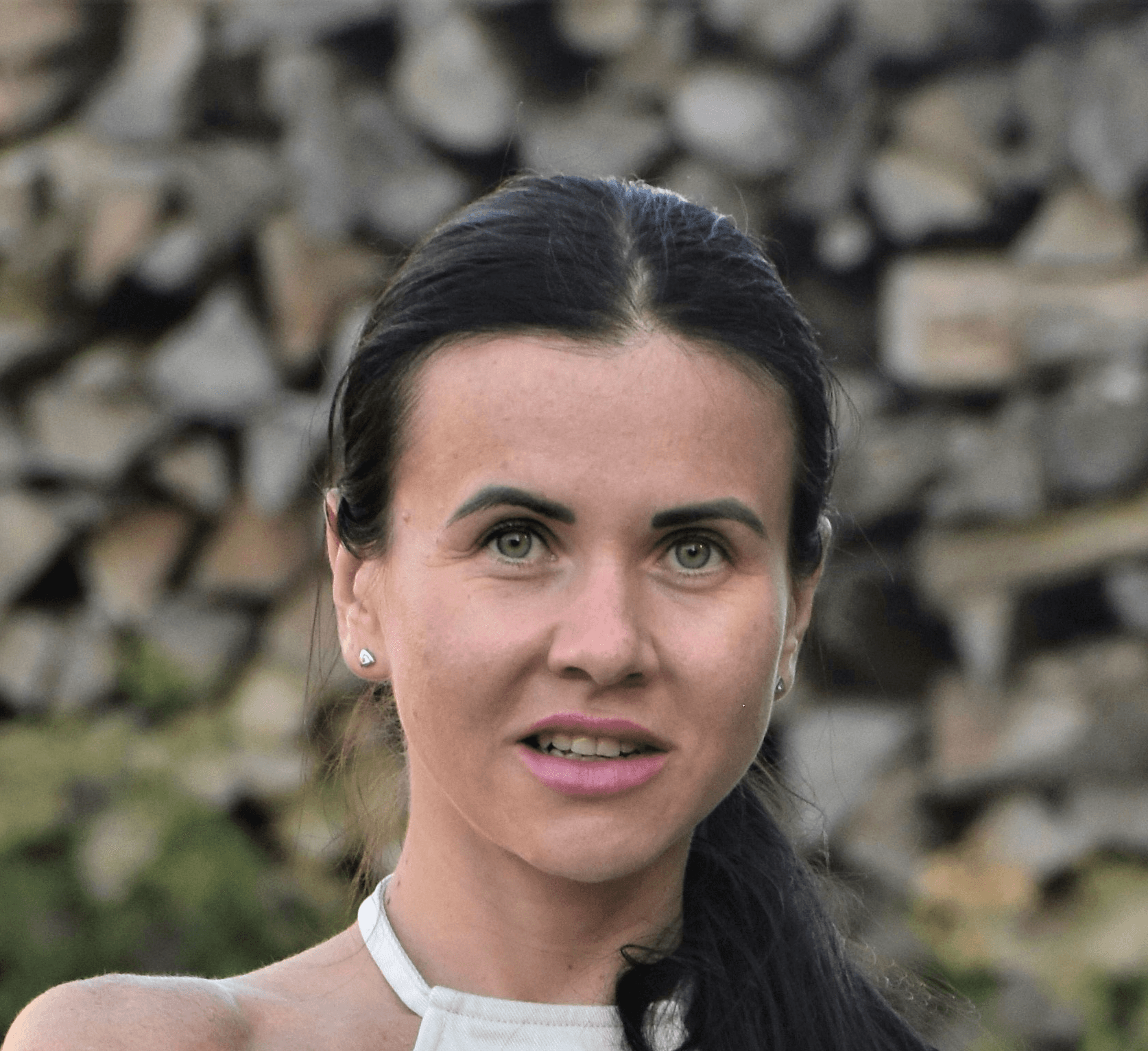a woman in a white dress giving a thumbs up
