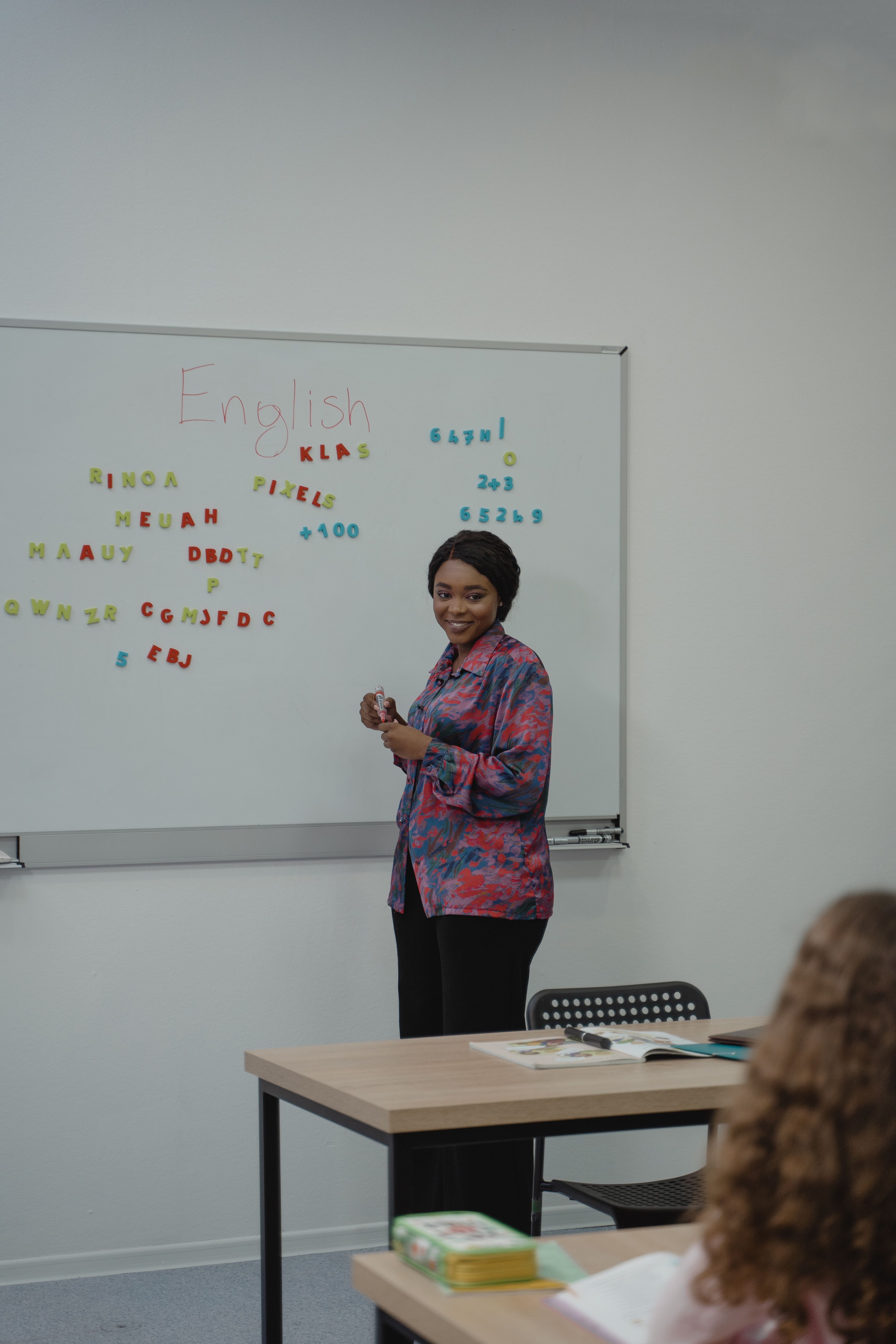 A teacher is explaining a topic, speaking with focus and using gestures to emphasize key points