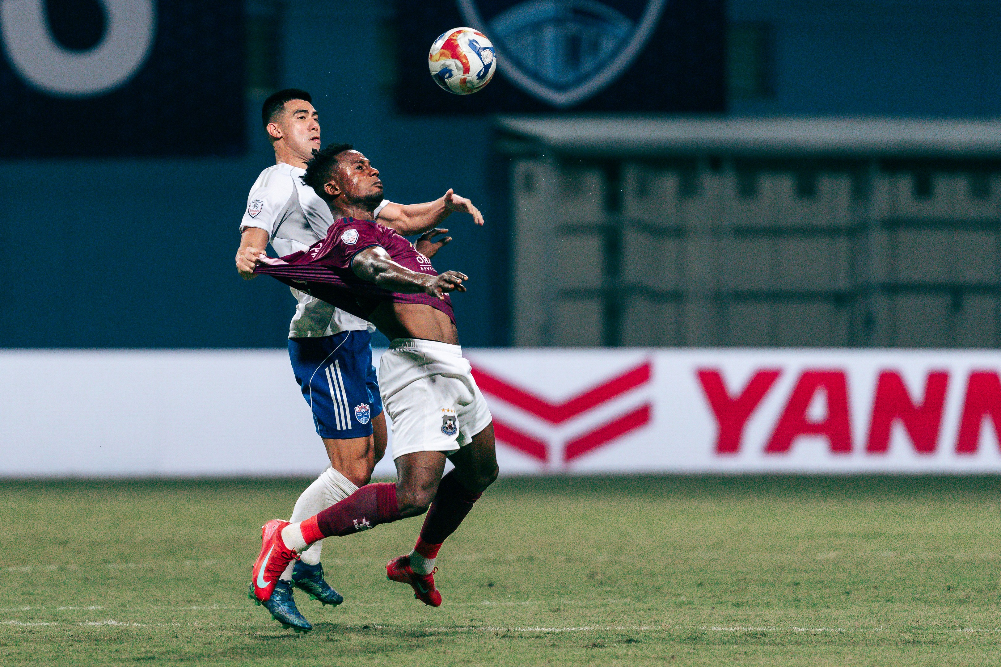 Lionel Tan challenges with Kwame Peprah for the ball during a match between Lion City Sailors and PKR Svay Rieng in the ASEAN Shopee Cup 2025/26 at Jalan Besar Stadium, 2025