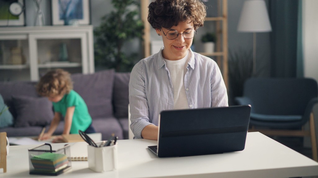 Mother working on a laptop at home
