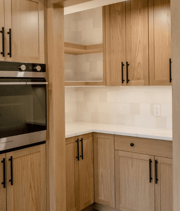 Image of "KHD Homes kitchen design with island, stainless steel appliances, and elegant lighting fixtures for home renovations."