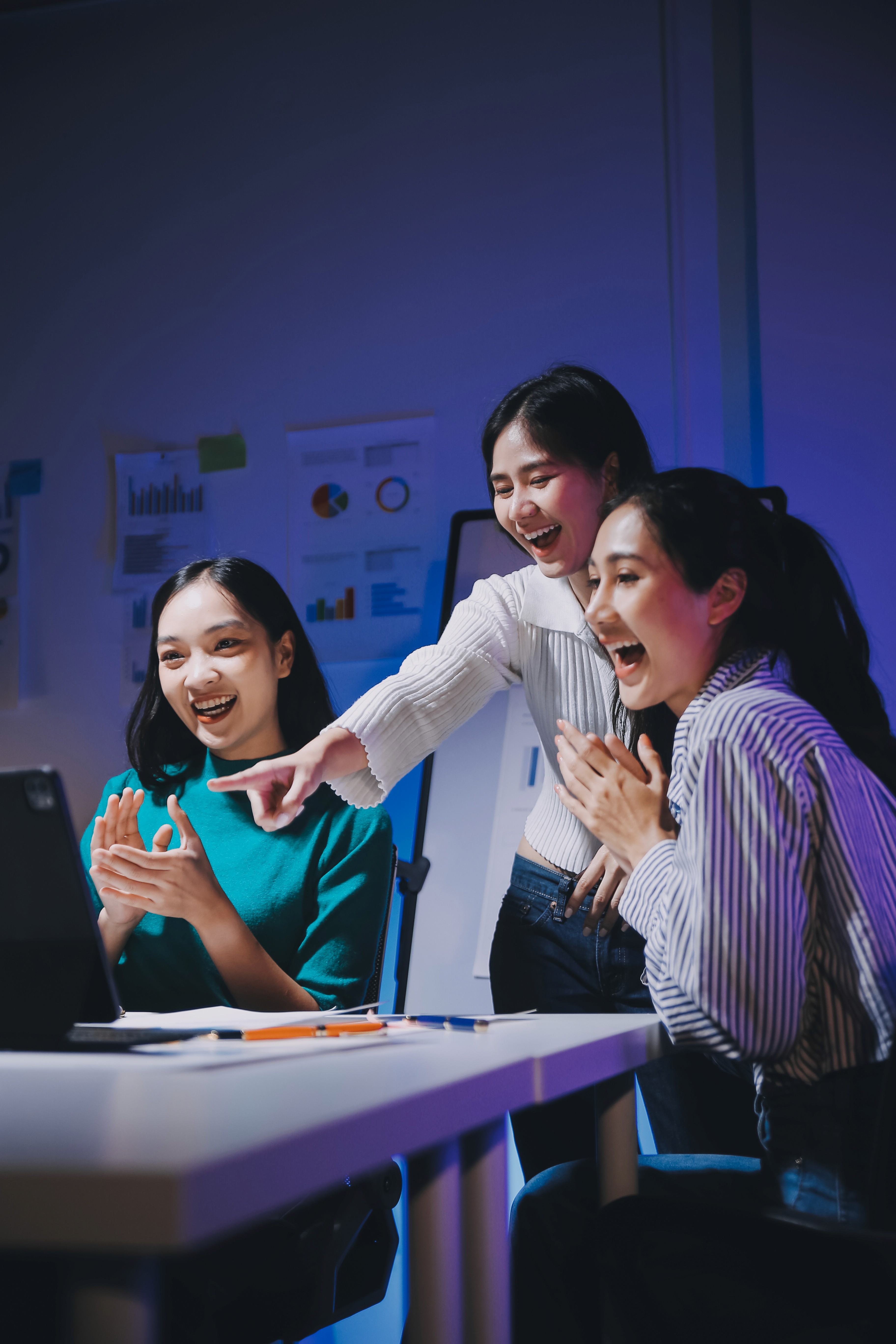 man standing in front of people sitting beside table with laptop computers