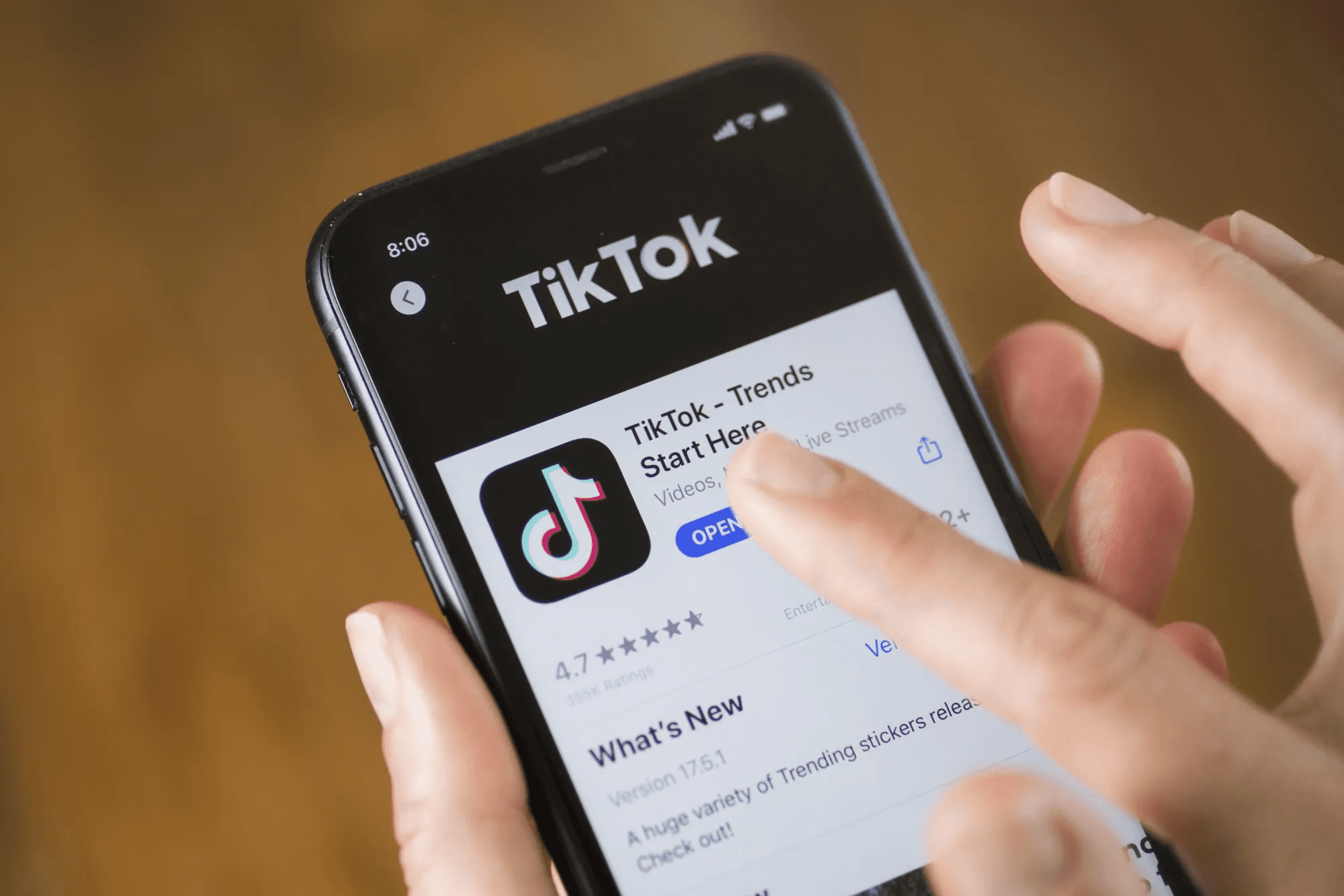 Finger pointing TikTok app - Why Is My Content Under Review on TikTok