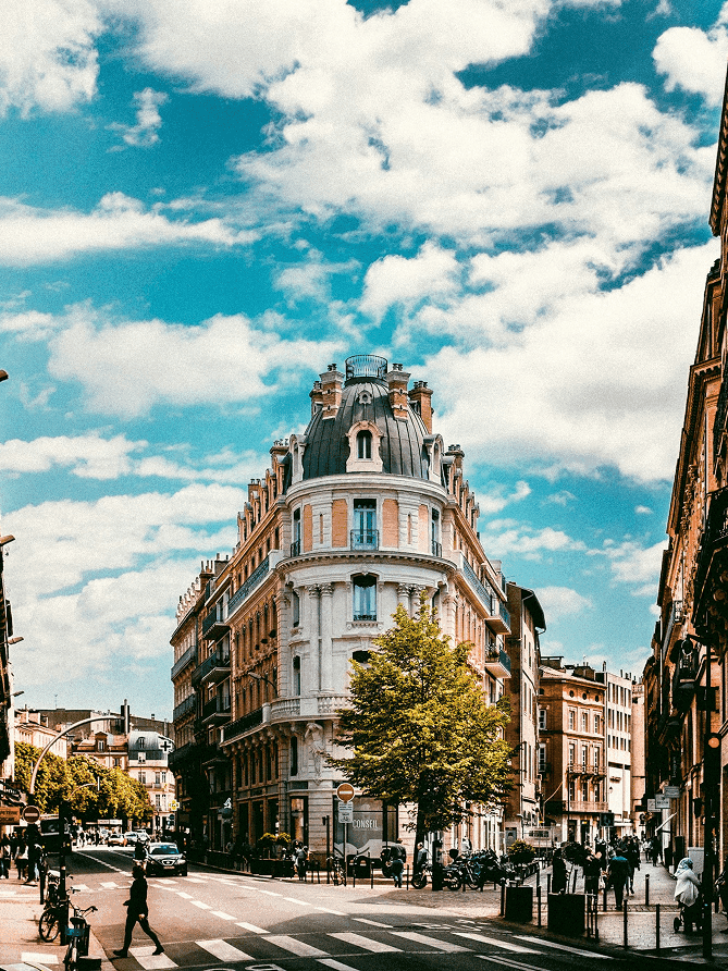 an airplane flying in the sky over a building