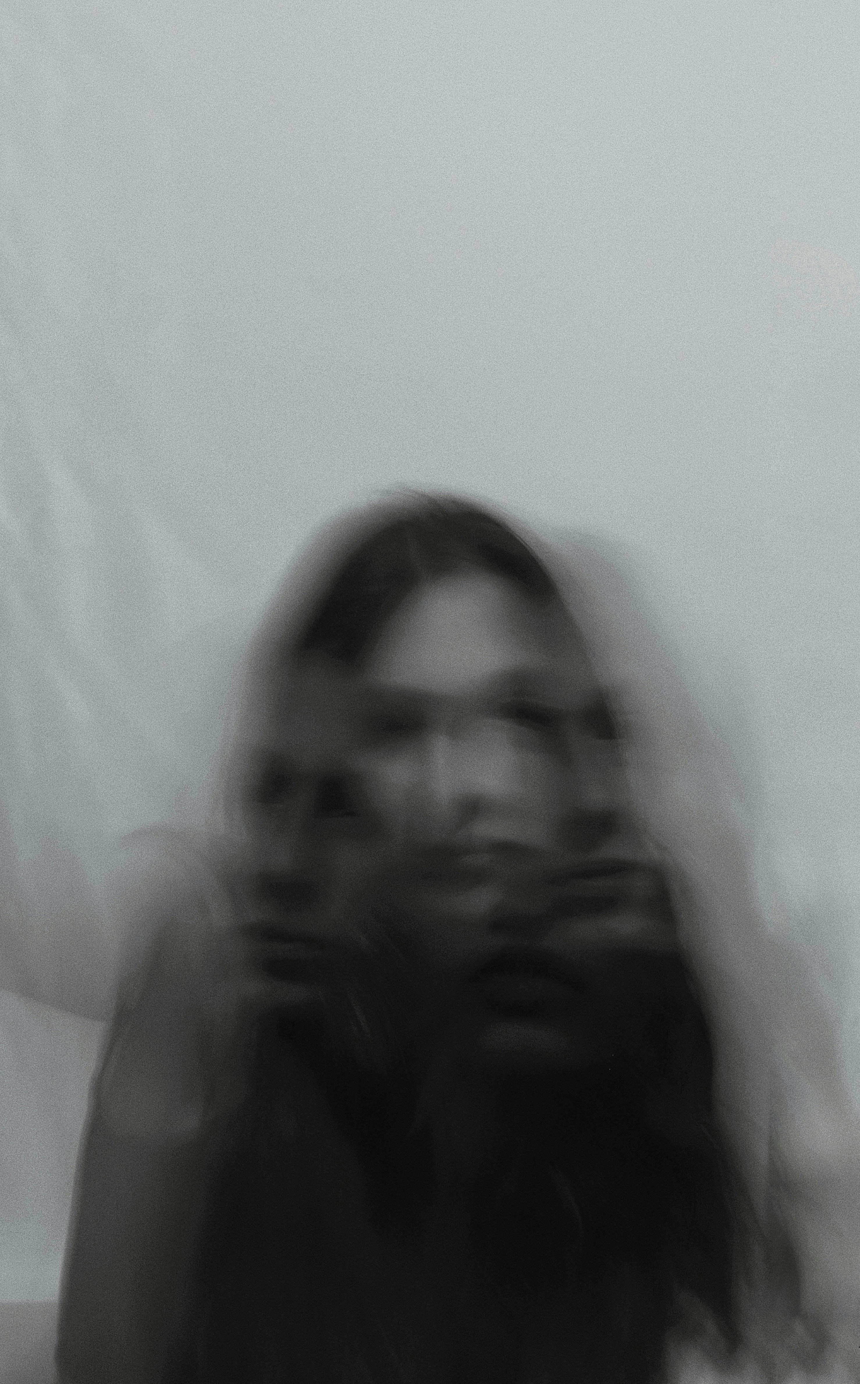 a blurry photo of a woman holding a cell phone