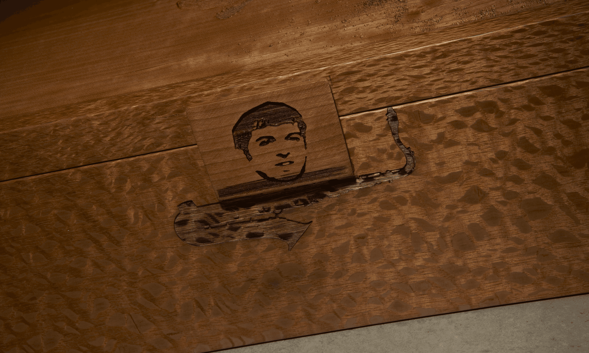 cropped detail of custom, lasered wooden closed shoe box