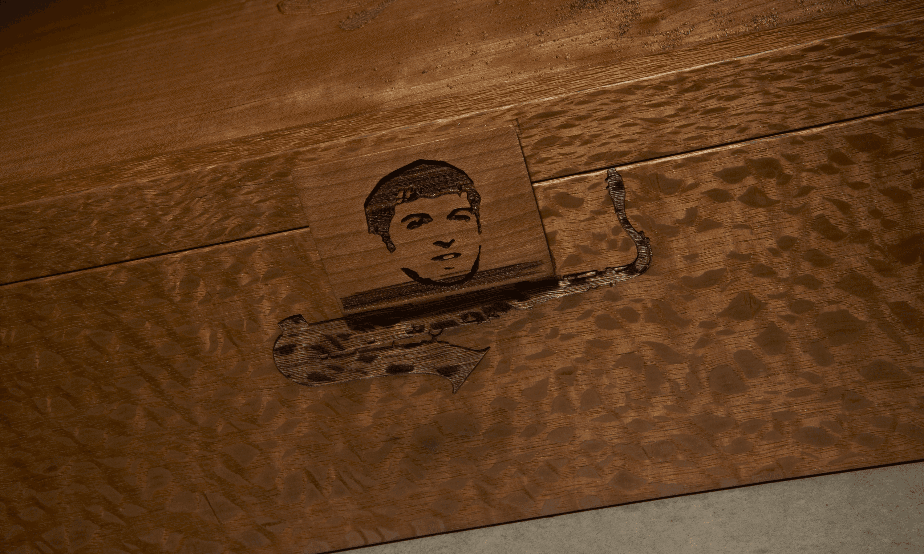 cropped detail of custom, lasered wooden closed shoe box