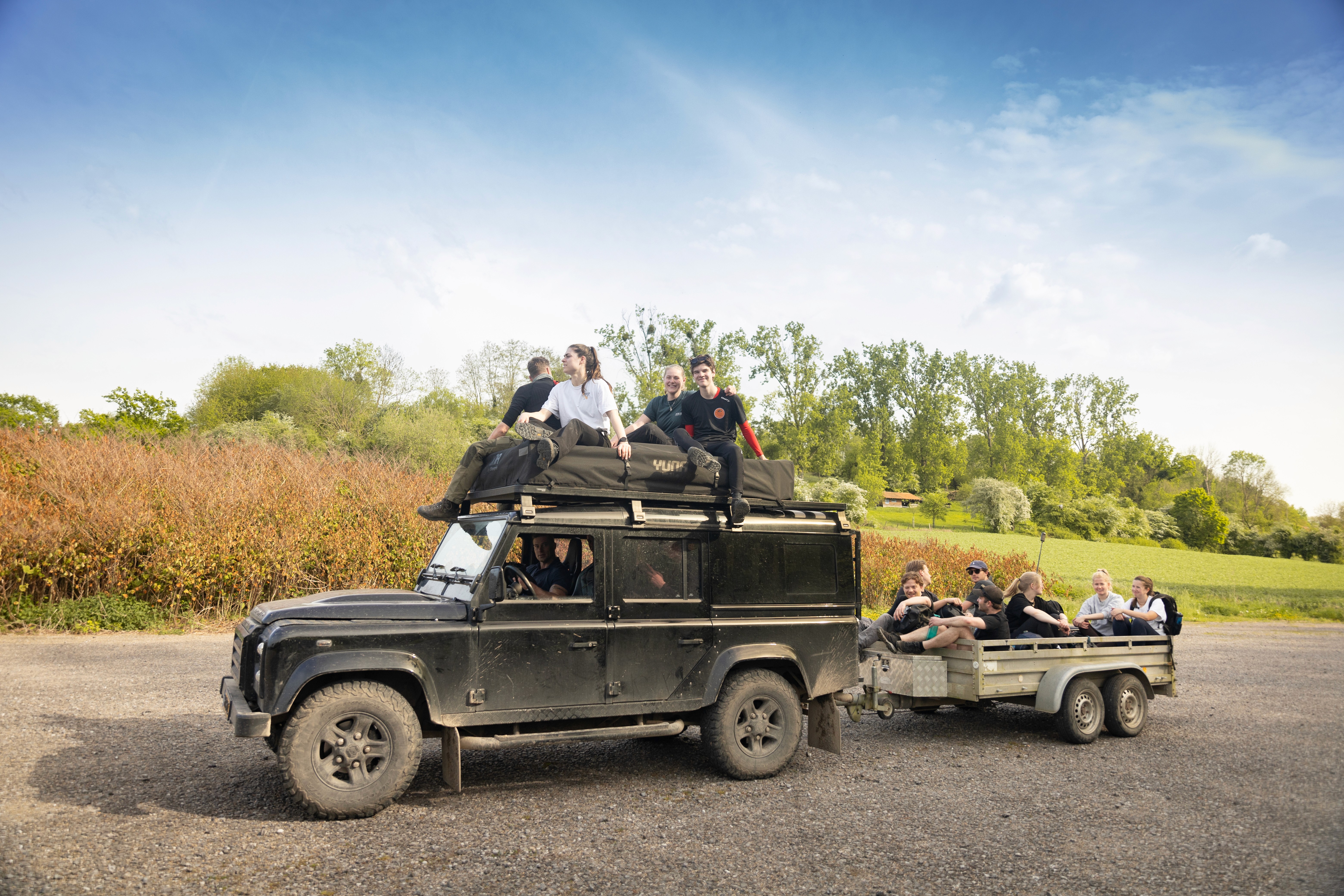 Close-up of a dark green leaf showing its textured surface and central vein against a muted background.