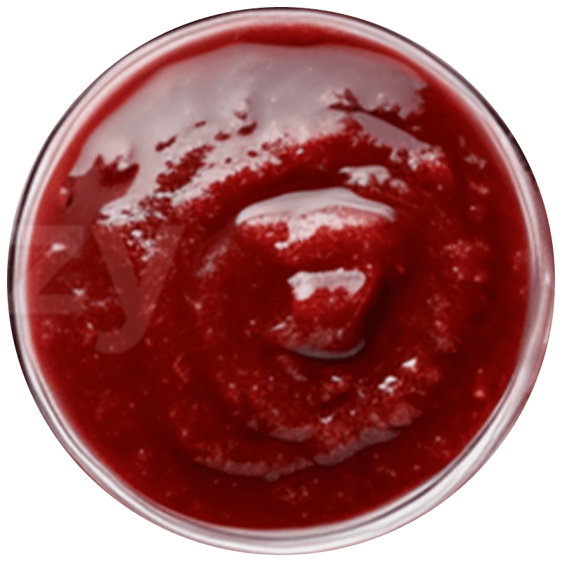 A bright, modern dining room featuring a long light wood table set with several matching wooden chairs and white cushions, illuminated by natural light streaming through large windows overlooking a lush green and sunlit yard.