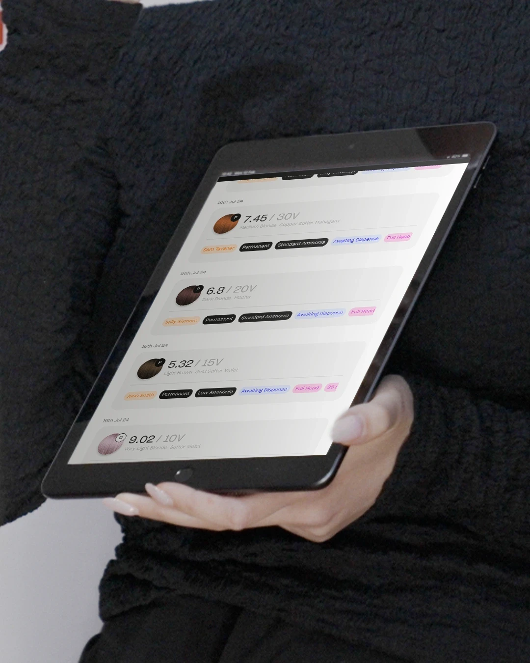 A person holding the iPad showing the yuv® App homepage with the formulas listed.